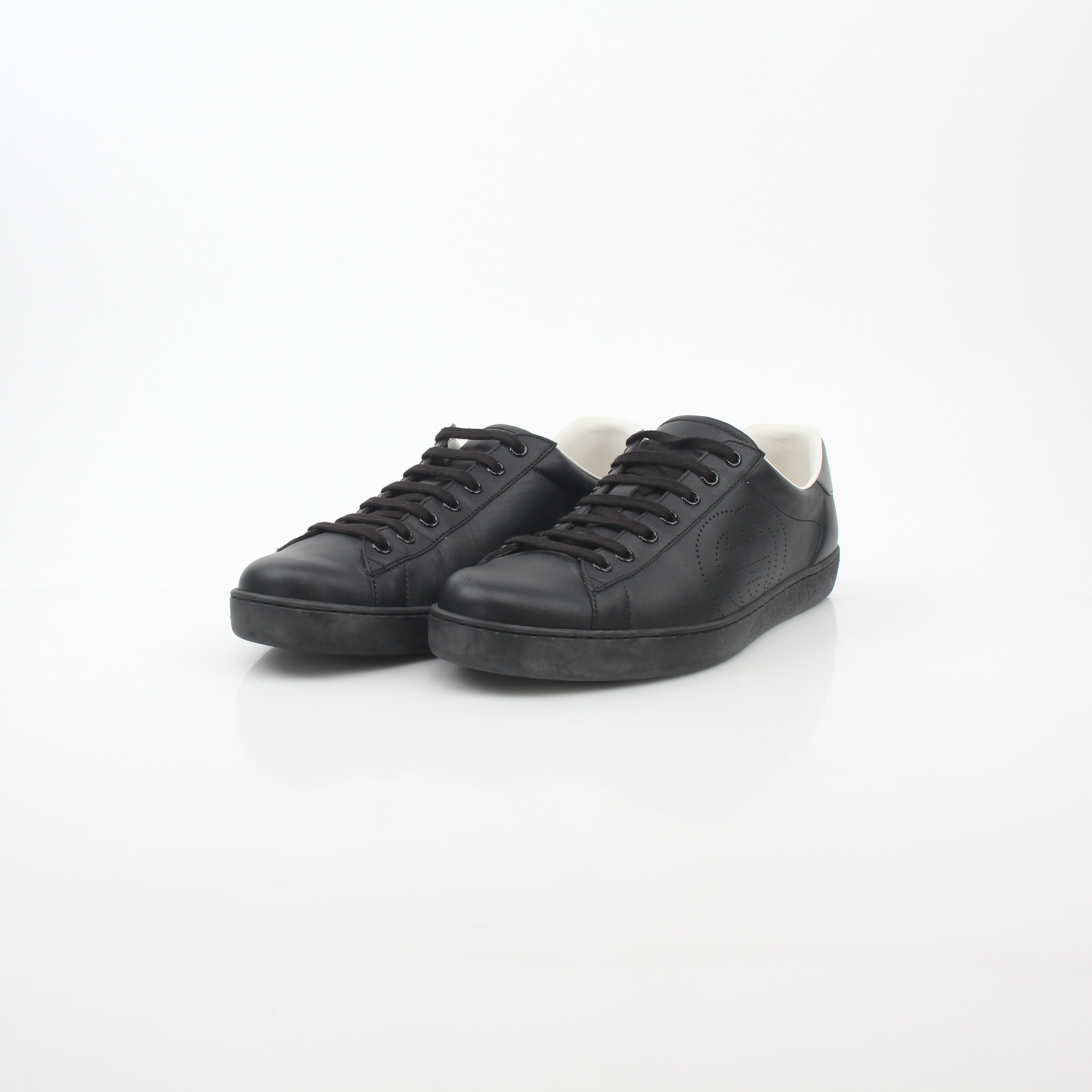Gold & Beyond Gucci black leather Brooklyn low-top sneakers with sleek design and classic lace-up style.