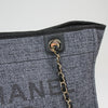Chanel Deauville tweed tote in elegant design, showcasing textured fabric and spacious interior for daily use.