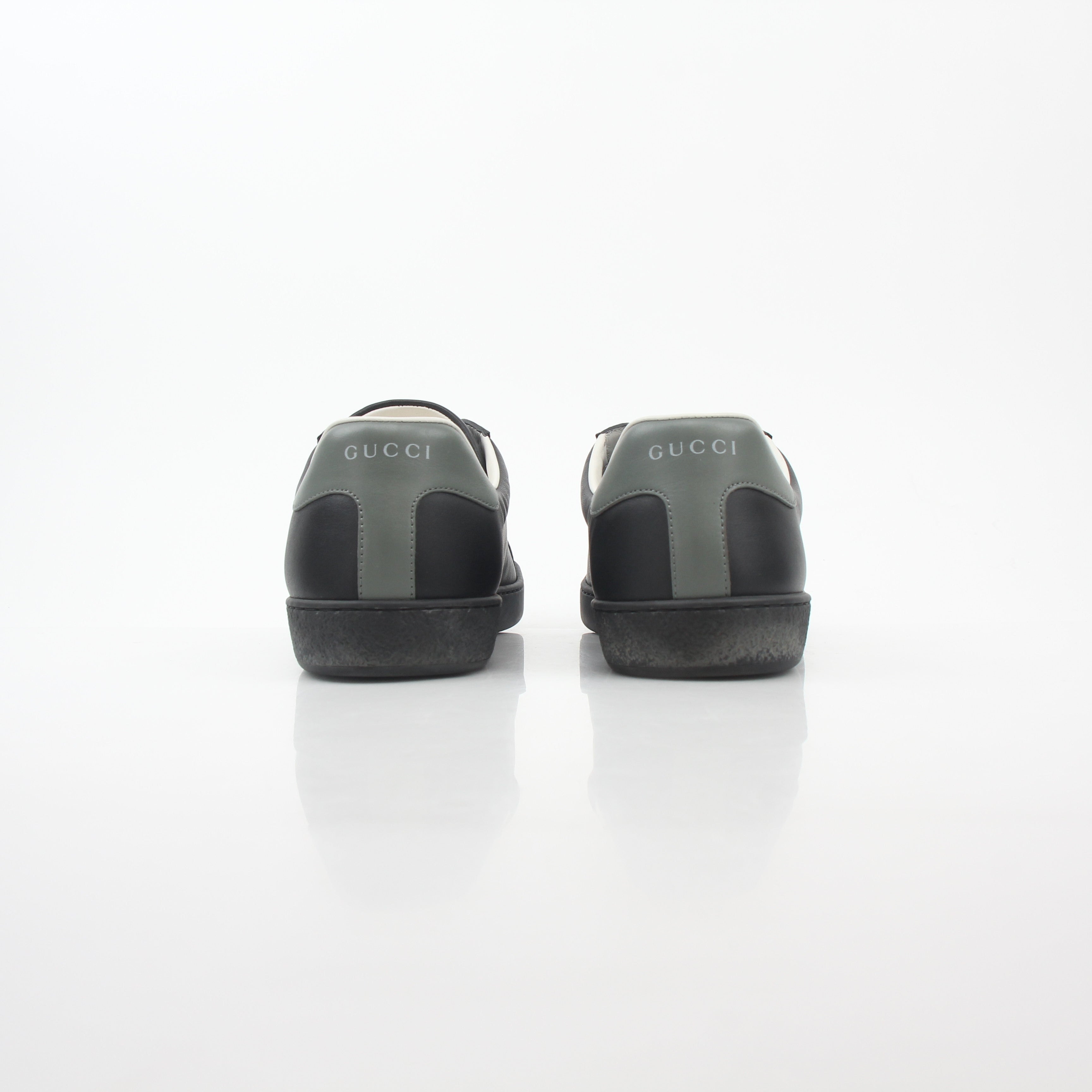 Gucci black leather Brooklyn low-top sneakers with white rubber soles and Gucci logo detail, stylish shoes for casual wear.