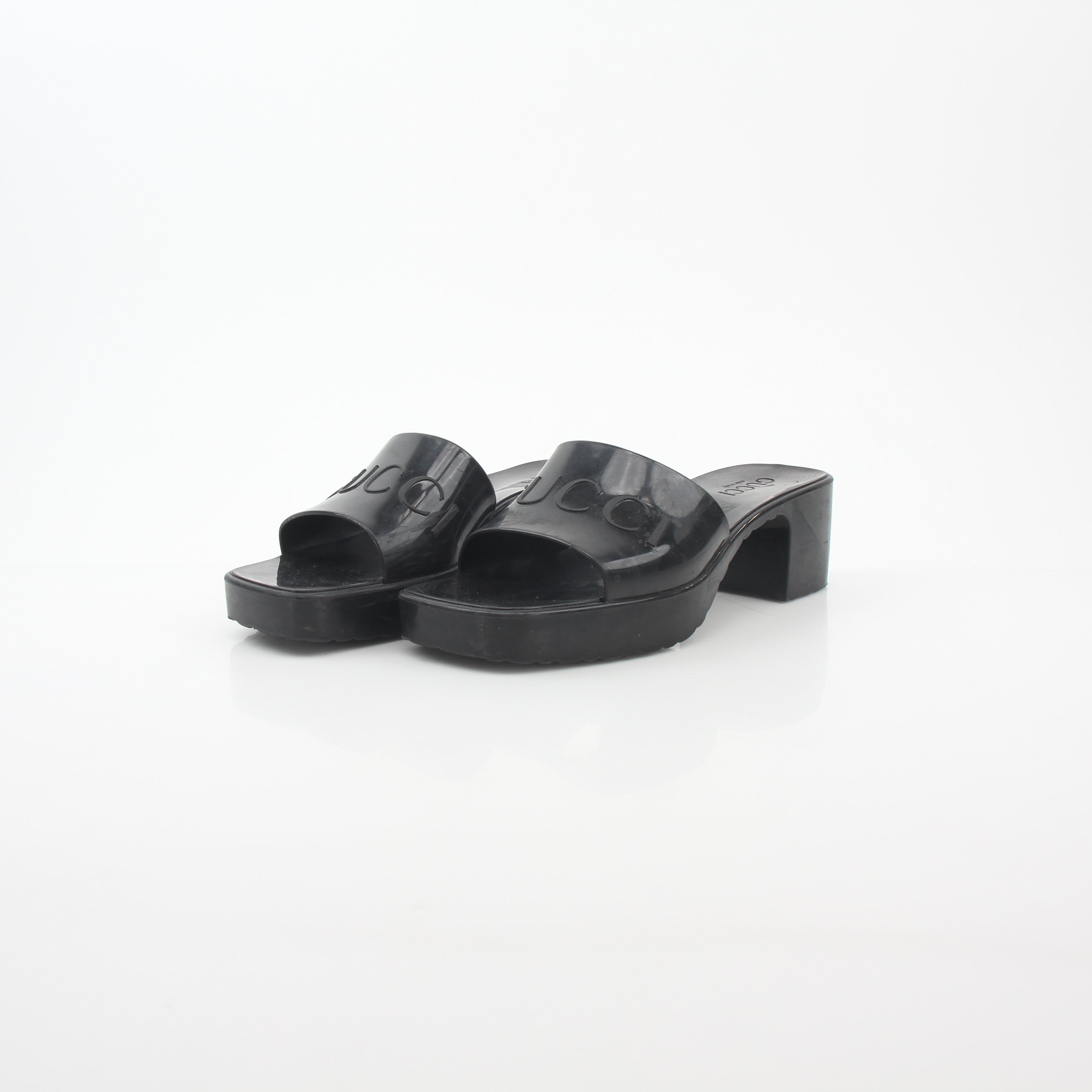 Gucci black rubber platform slide sandals with logo straps, stylish and comfortable shoes for casual wear.