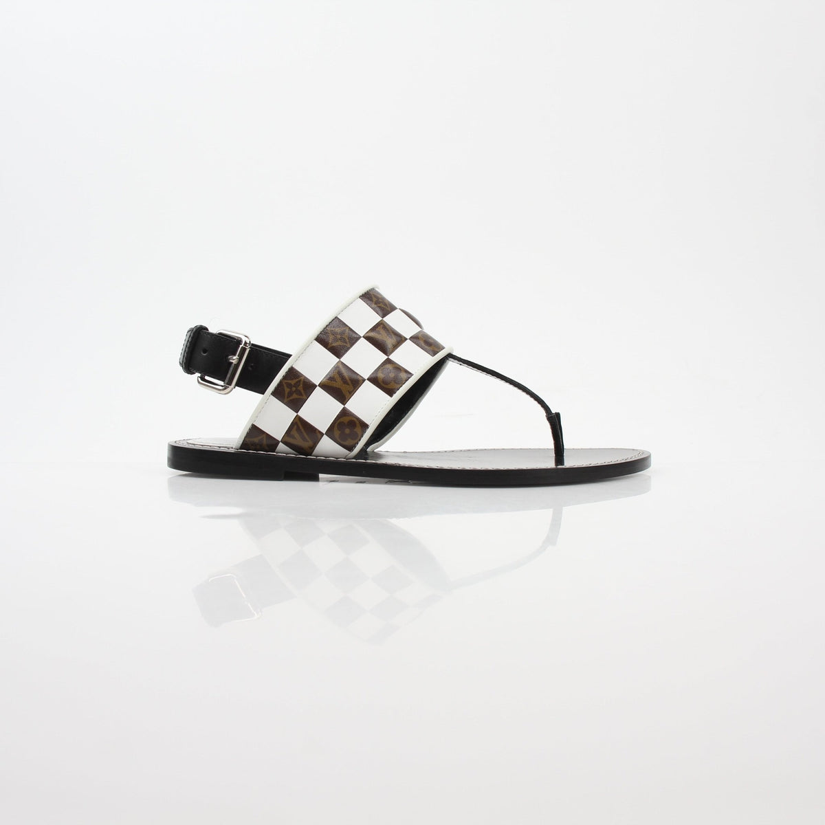 Louis Vuitton black and white monogram Matchmake flat thong sandals with gold accents, designed for stylish comfort.