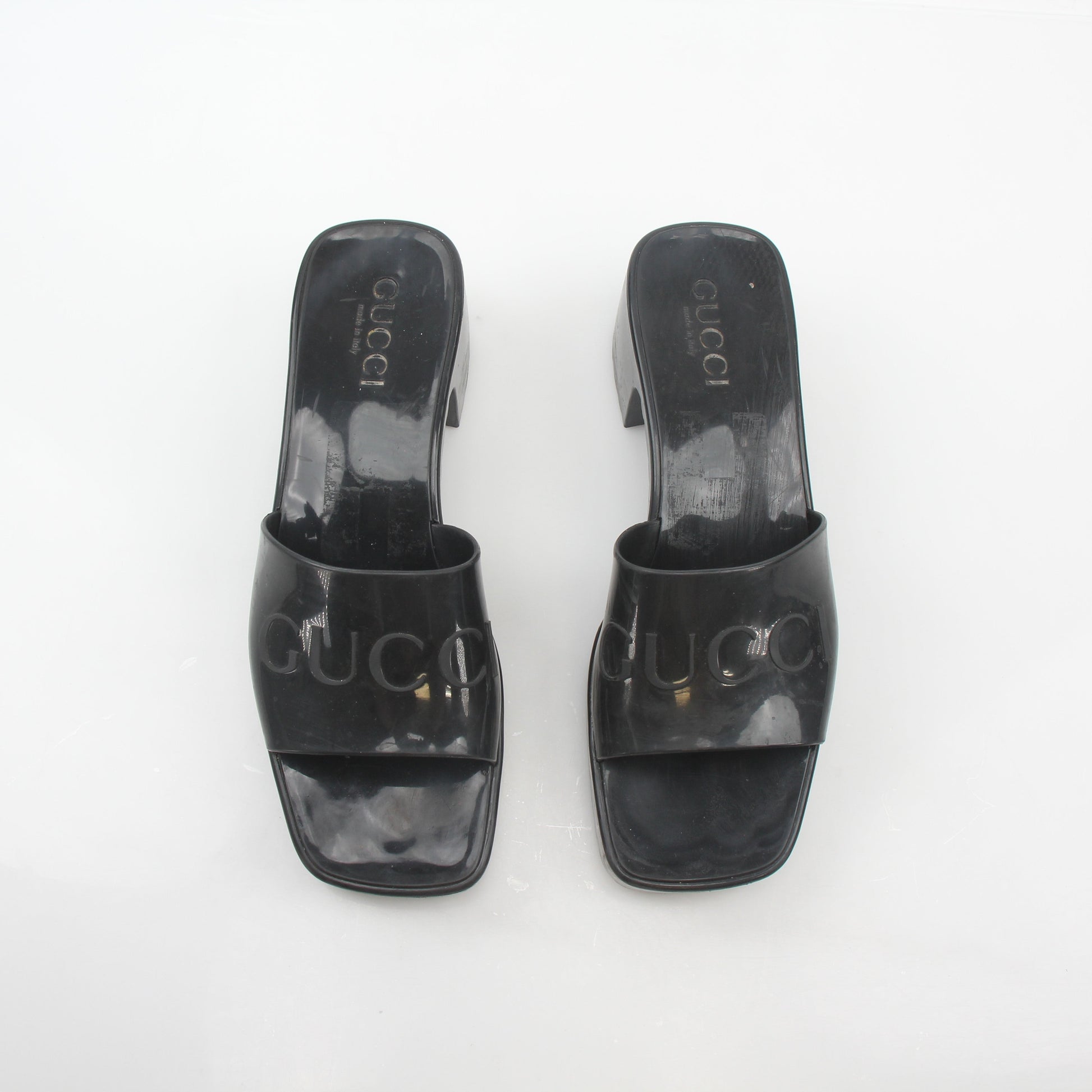Gucci black rubber logo platform slide sandals with chunky sole and branded strap, stylish and comfortable footwear.