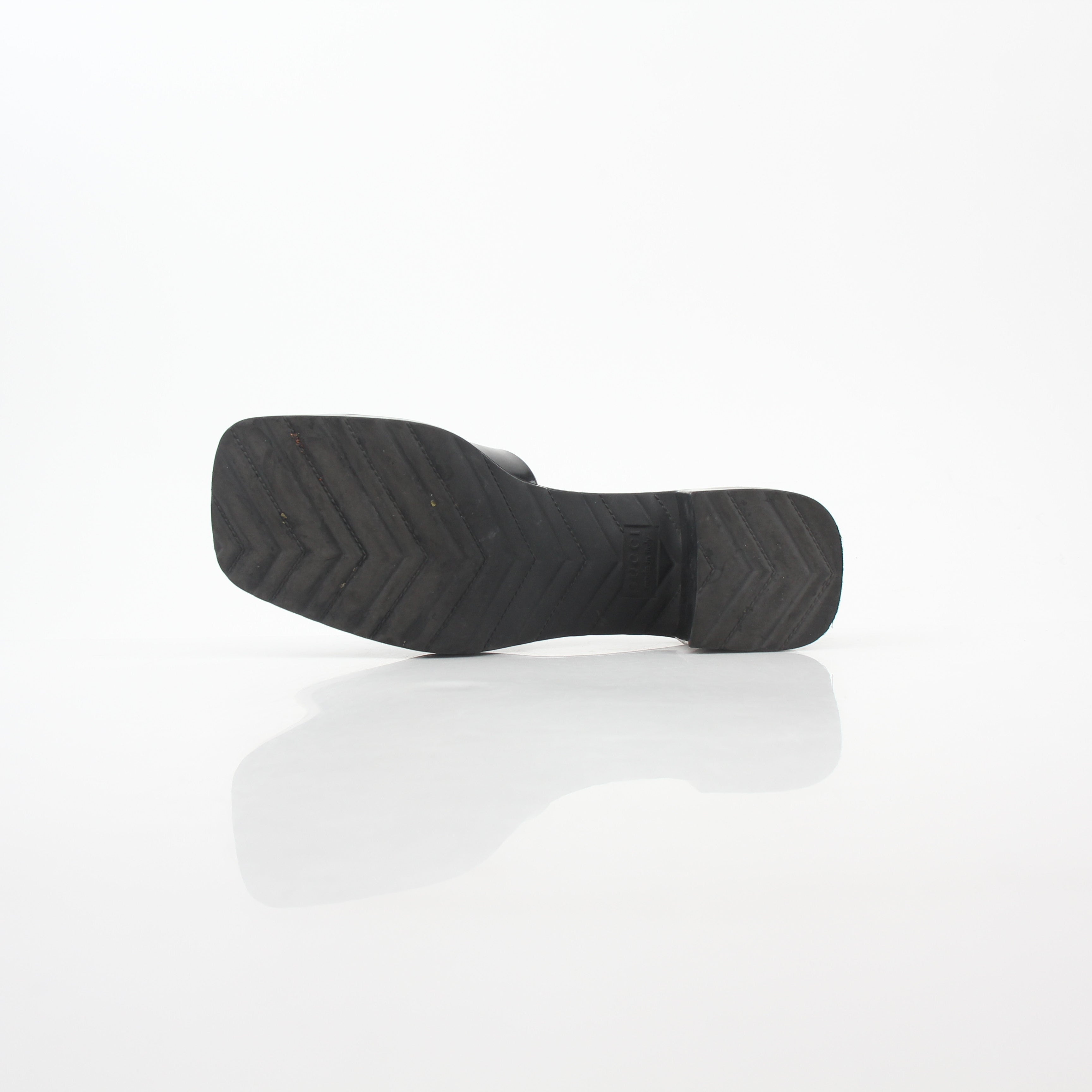Gucci black rubber logo platform slide sandals featuring a sleek strap design and chunky platform sole.