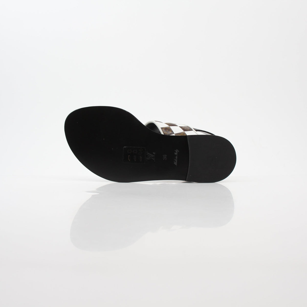 Louis Vuitton black and white monogram Matchmake flat thong sandals with gold accents, designer shoes for casual or summer wear.