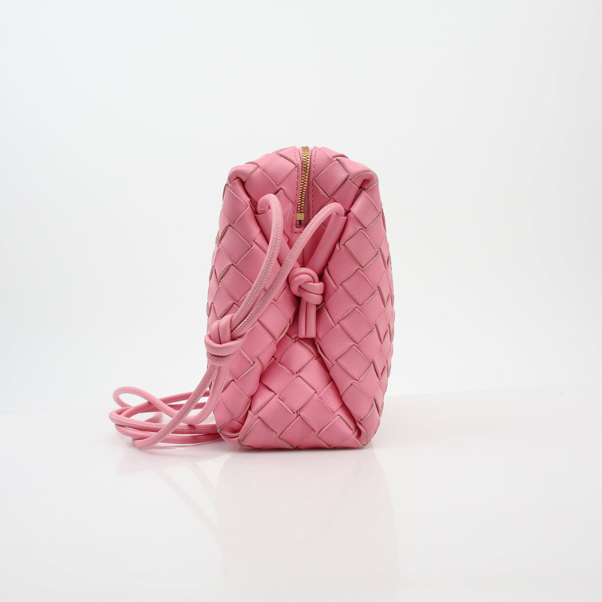 Pink Bottega Veneta Intrecciato Loop Camera Bag handbag with woven leather design and gold chain strap.