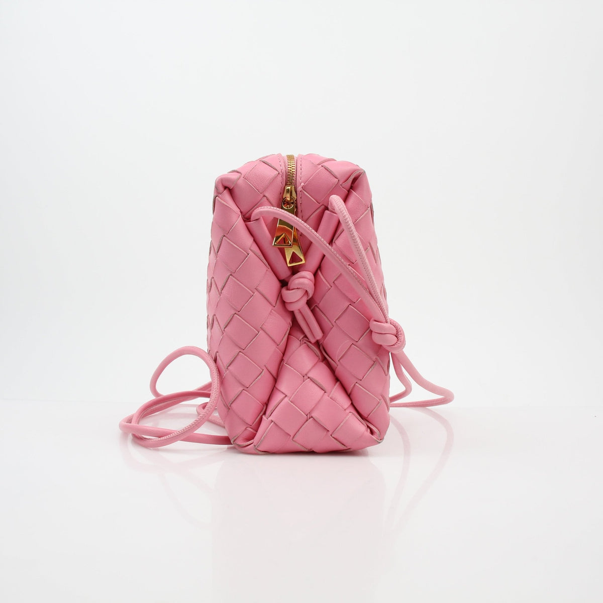 Pink Bottega Veneta Intrecciato Loop Camera Bag handbag with woven leather design and silver hardware, featuring a shoulder strap.