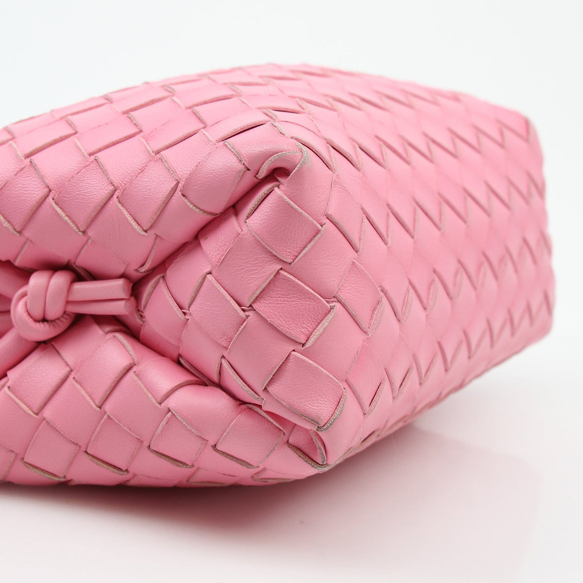 Pink Bottega Veneta Intrecciato Loop Camera Bag handbag with woven leather design, featuring a loop strap and gold-tone hardware.