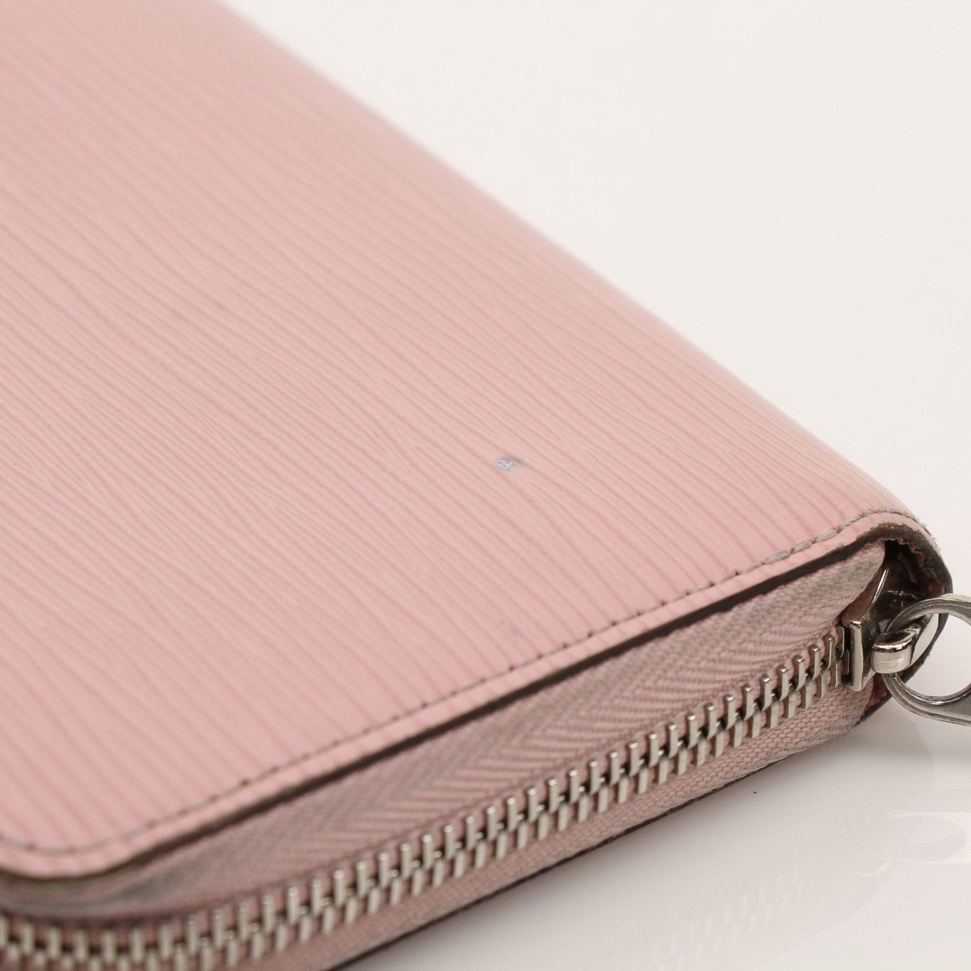 Louis Vuitton Epi Zippy Wallet with gold hardware, showcasing textured leather and multiple card slots on a neutral background.