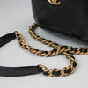 Chanel Matelassé vanity shoulder bag in black leather with quilted design and gold hardware, displayed on a neutral background.
