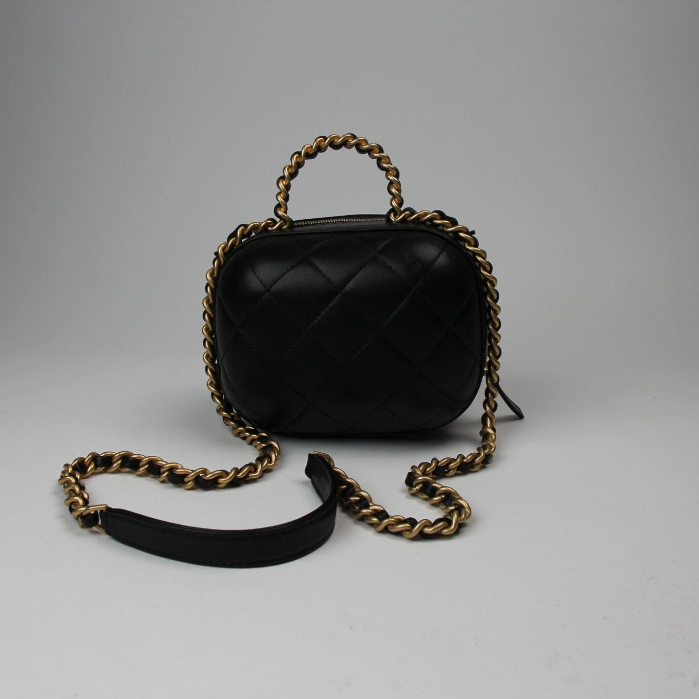 Chanel Matelassé Vanity Shoulder Bag in black leather with quilted design and gold hardware, showcasing elegant craftsmanship.