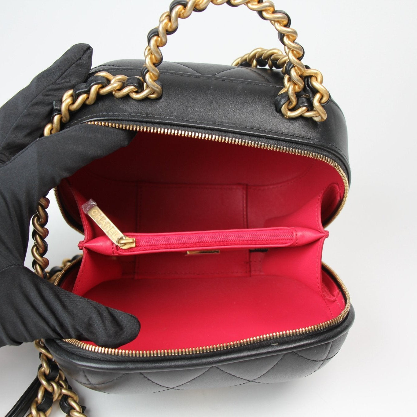 Chanel Matelassé Vanity Shoulder Bag in black leather with quilted design and gold chain strap, showcasing elegant craftsmanship.