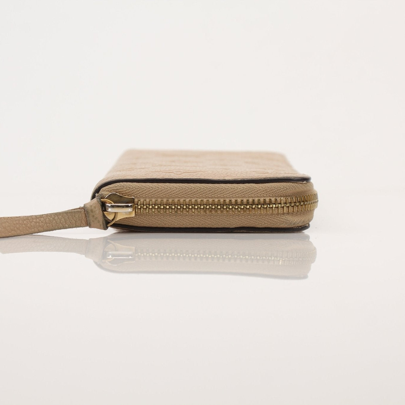 Louis Vuitton Empreinte Clemence Wallet with gold-tone hardware and embossed leather, displayed open showing card slots and interior compartments.