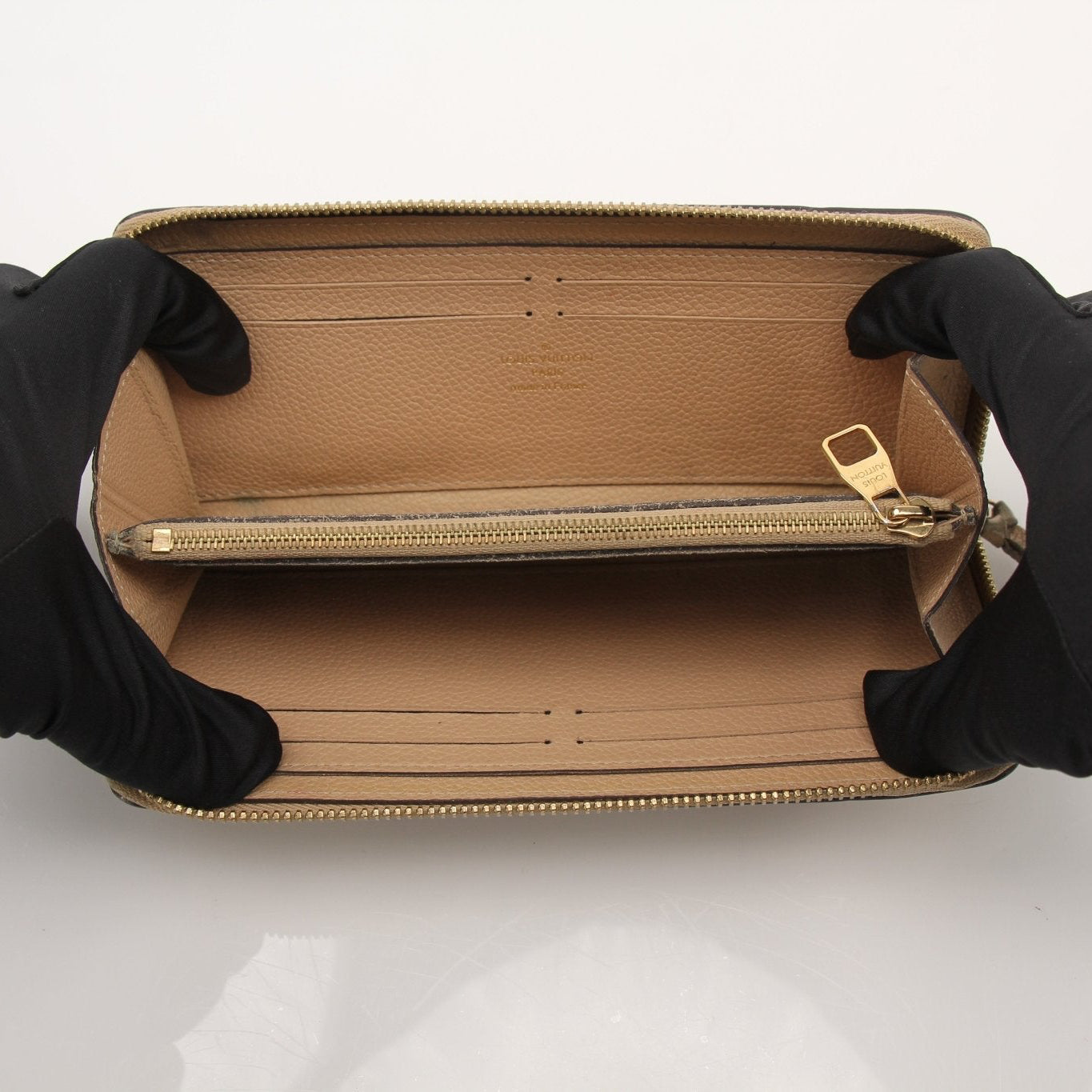 Louis Vuitton Empreinte Clemence wallet with gold-tone hardware and embossed leather, shown open with card slots and interior details.