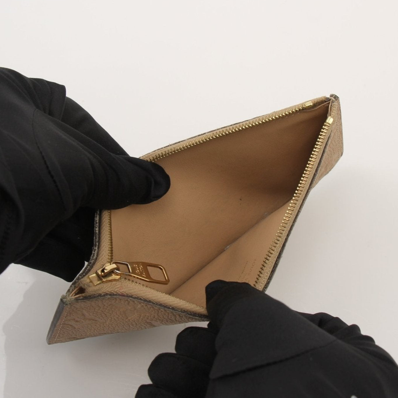 Louis Vuitton Empreinte Clemence Wallet in brown leather with gold hardware and embossed logo, shown open with card slots visible.