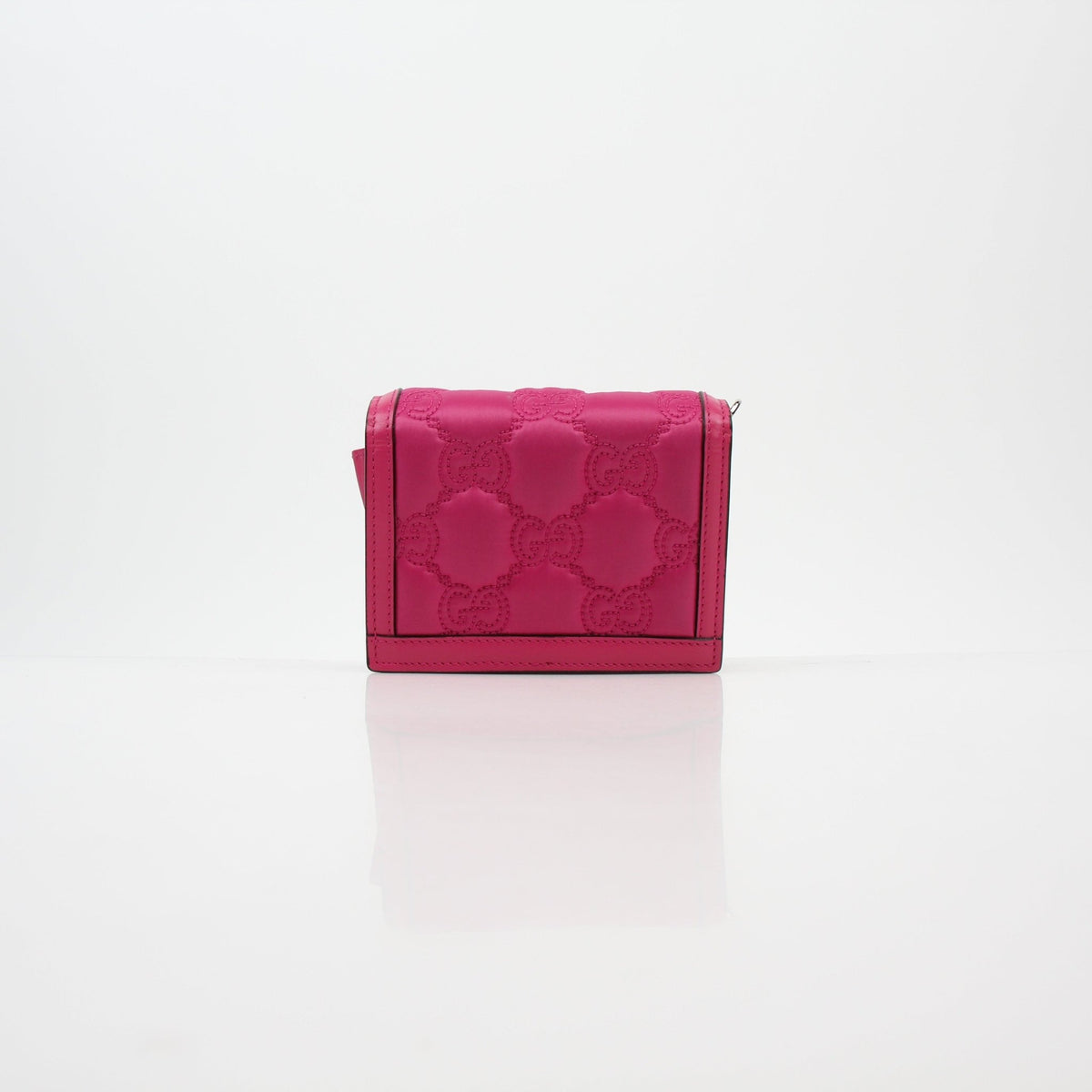 Gucci Fuchsia GG Matelassé Mini Wallet on Chain with gold hardware, compact design, and textured quilted leather.