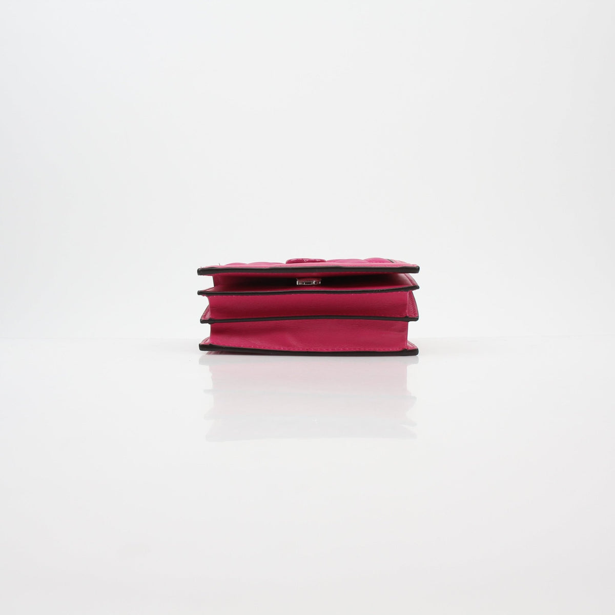 Gucci fuchsia GG matelassé mini wallet on chain with gold hardware, compact design, and quilted leather texture.