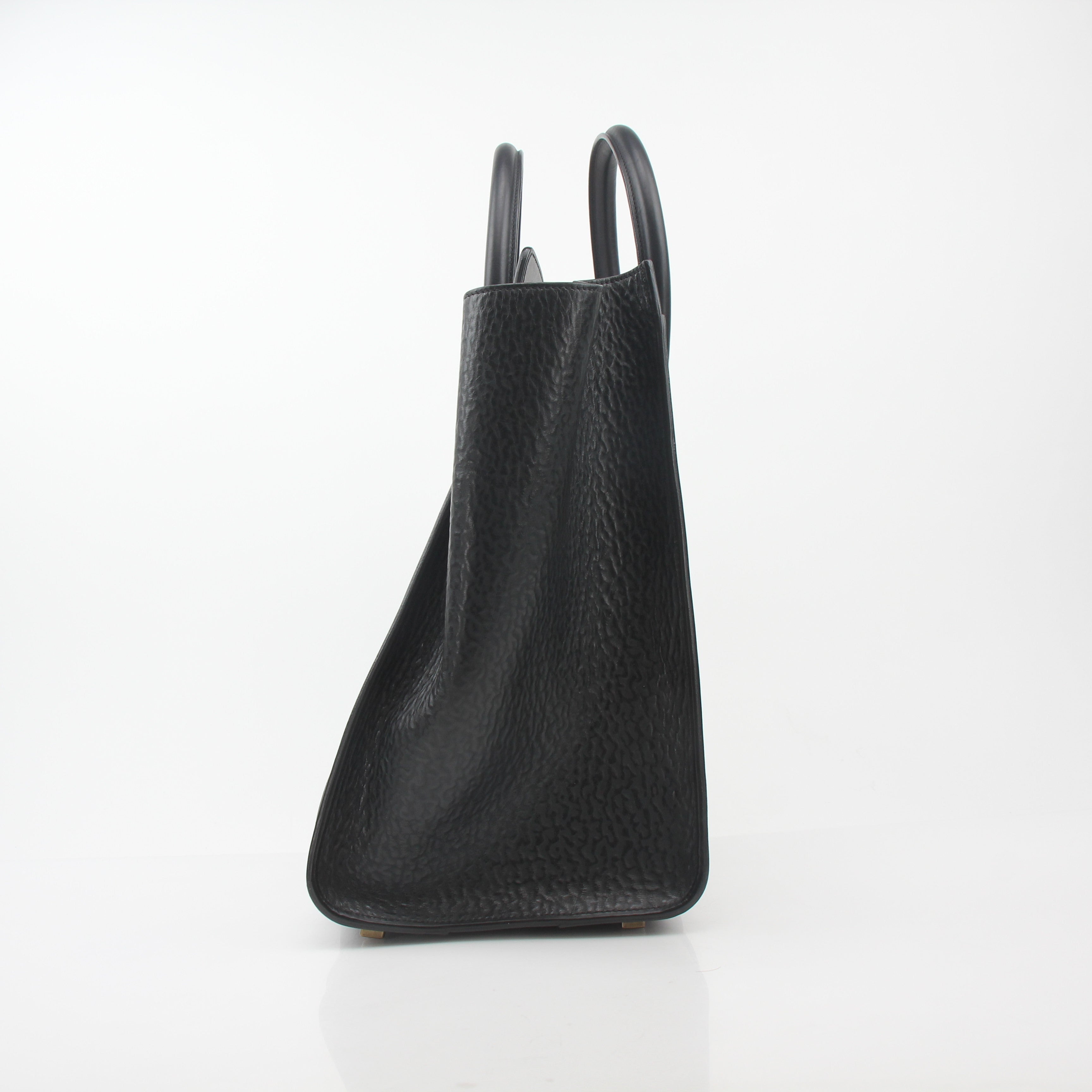Black Celine luggage tote handbag by Gold & Beyond, featuring structured design, twin top handles, and gold-tone hardware.