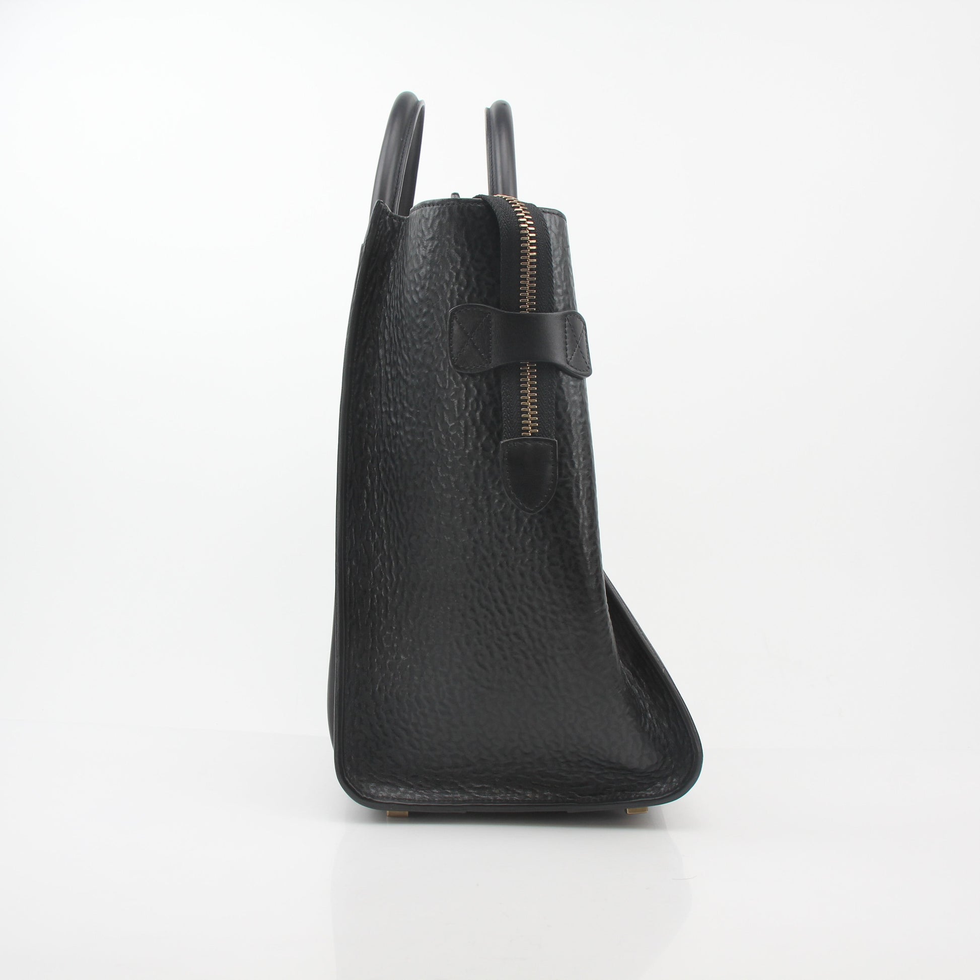 Black Celine luggage tote handbag with gold accents, featuring sleek leather design and structured shape.
