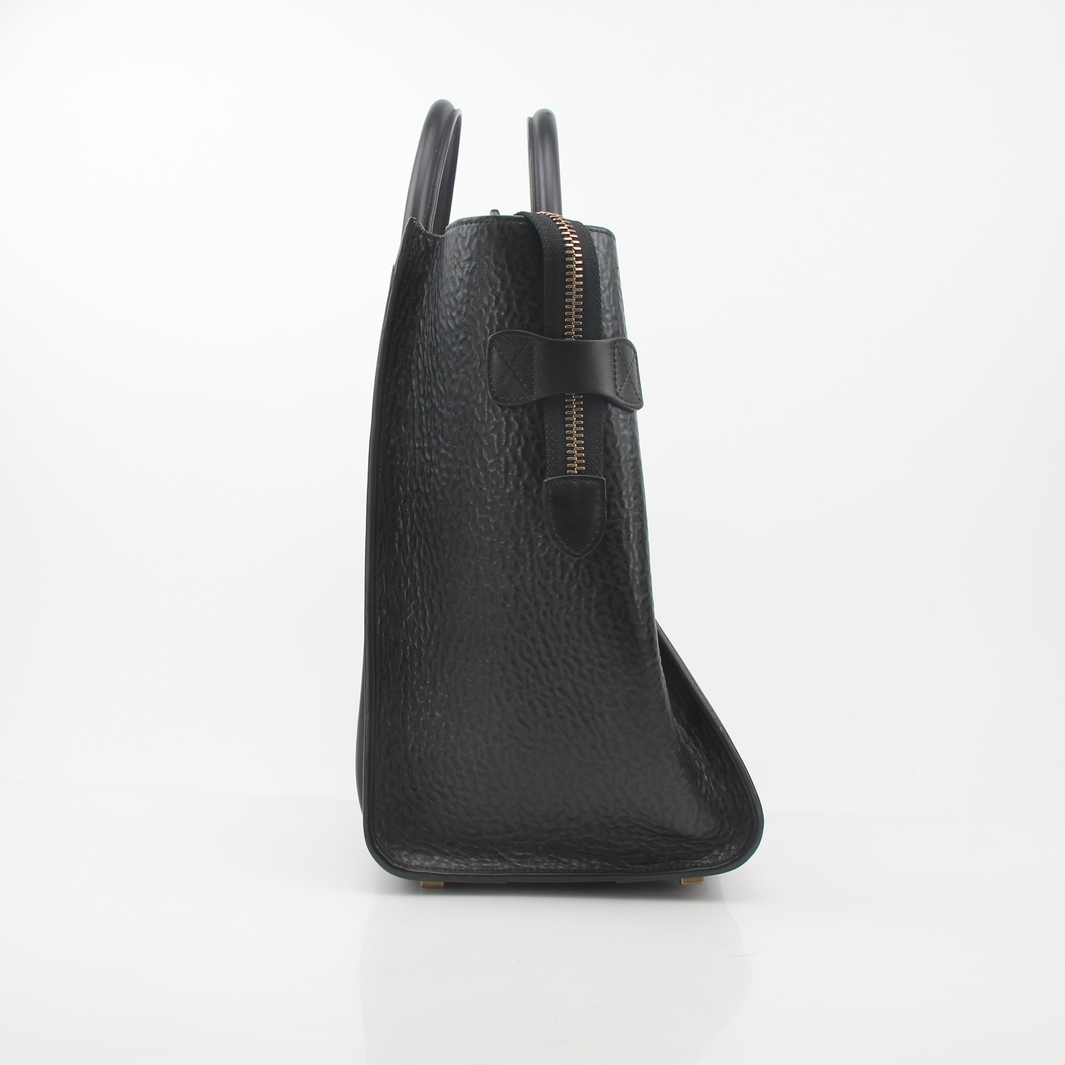 Black Celine luggage tote handbag with gold accents, featuring sleek leather design and structured shape.
