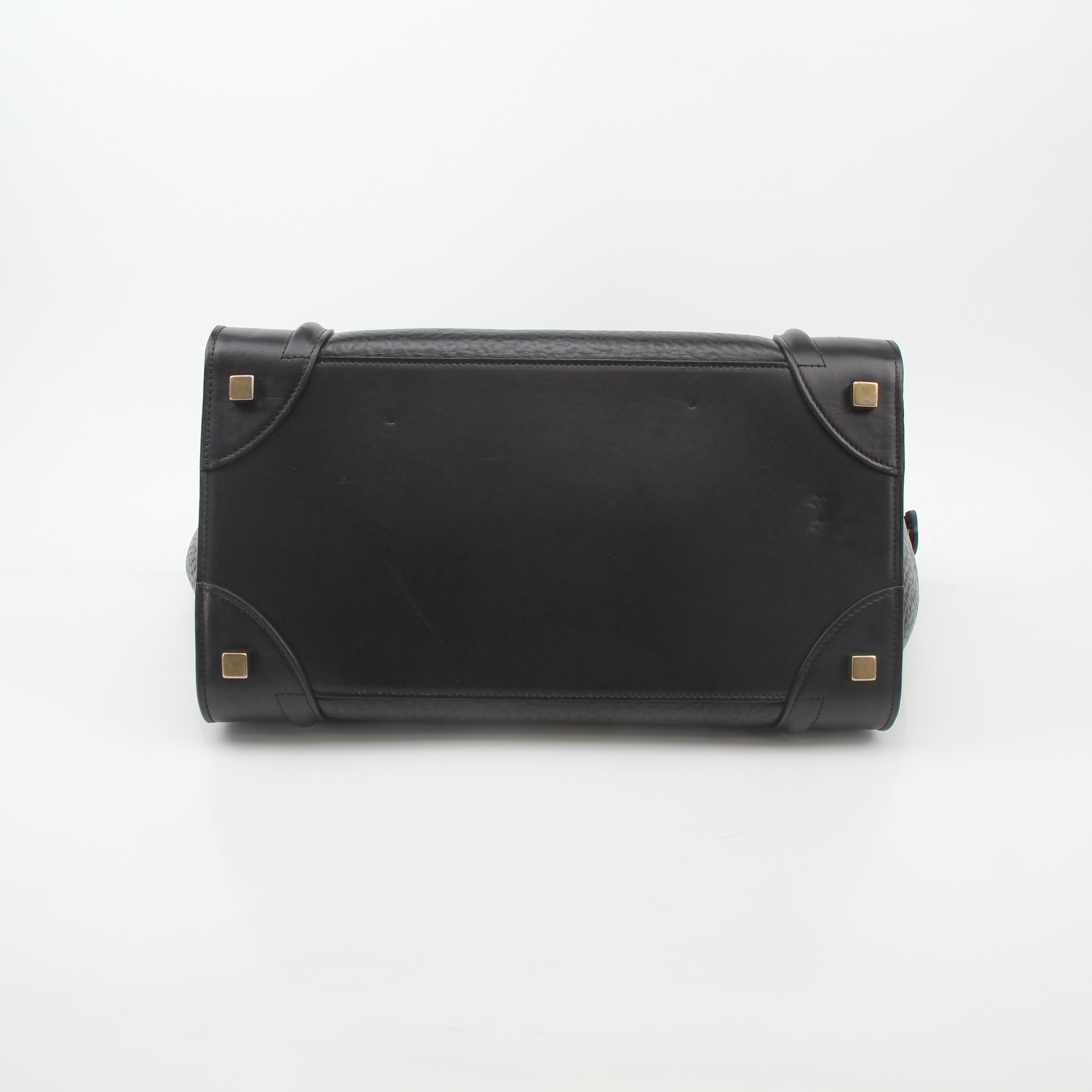 Black Celine luggage tote handbag by Gold & Beyond with top handles and structured design, shown on white background.