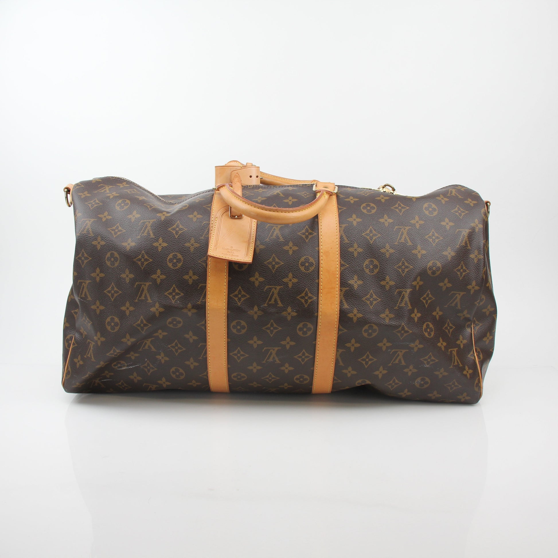 Louis Vuitton Monogram Keepall Bandoulière 55 travel duffel bag with leather handles and gold-tone hardware, featuring iconic monogram pattern.