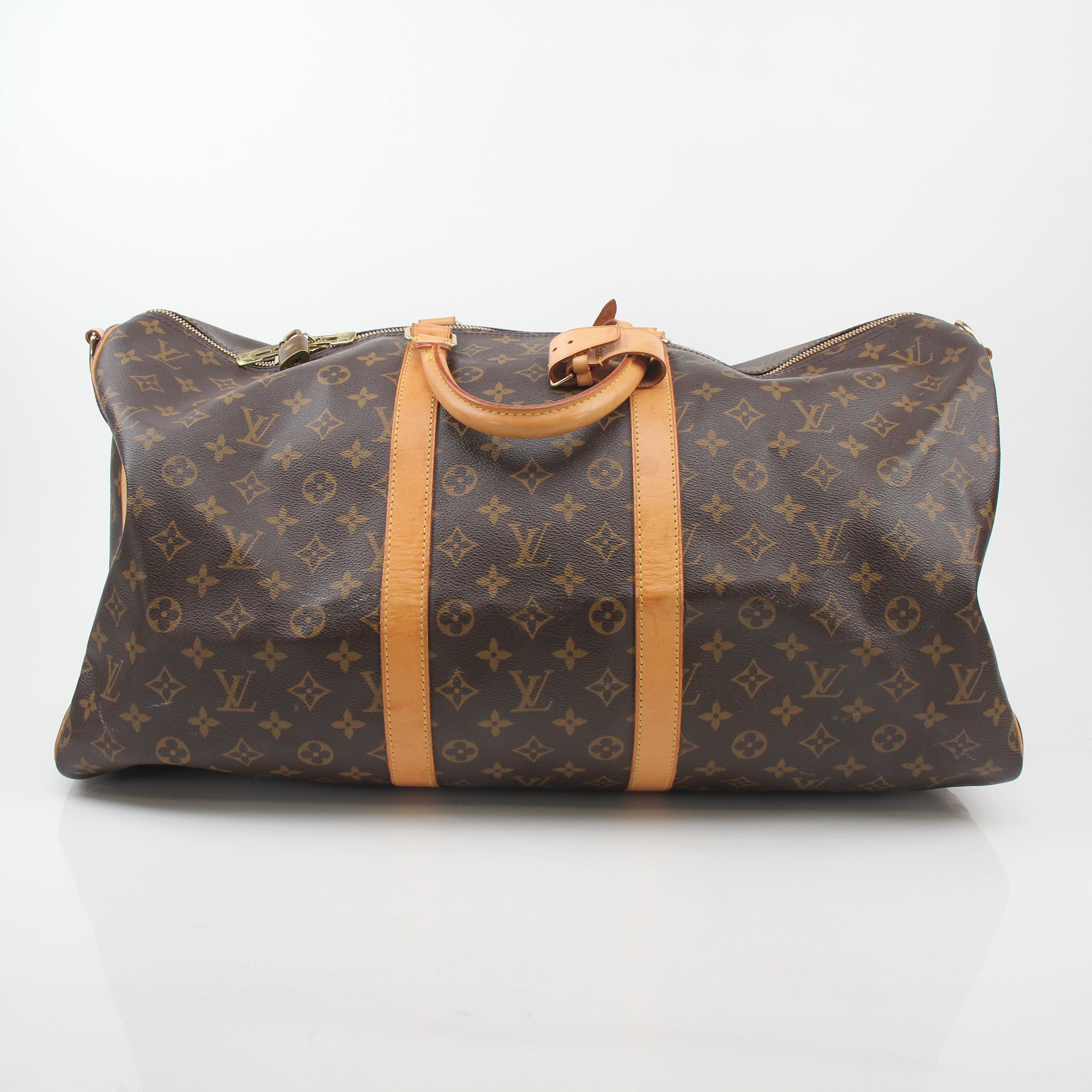 Louis Vuitton Monogram Keepall Bandoulière 55 duffel bag with leather trim, showcasing its iconic monogram canvas and sturdy handles.