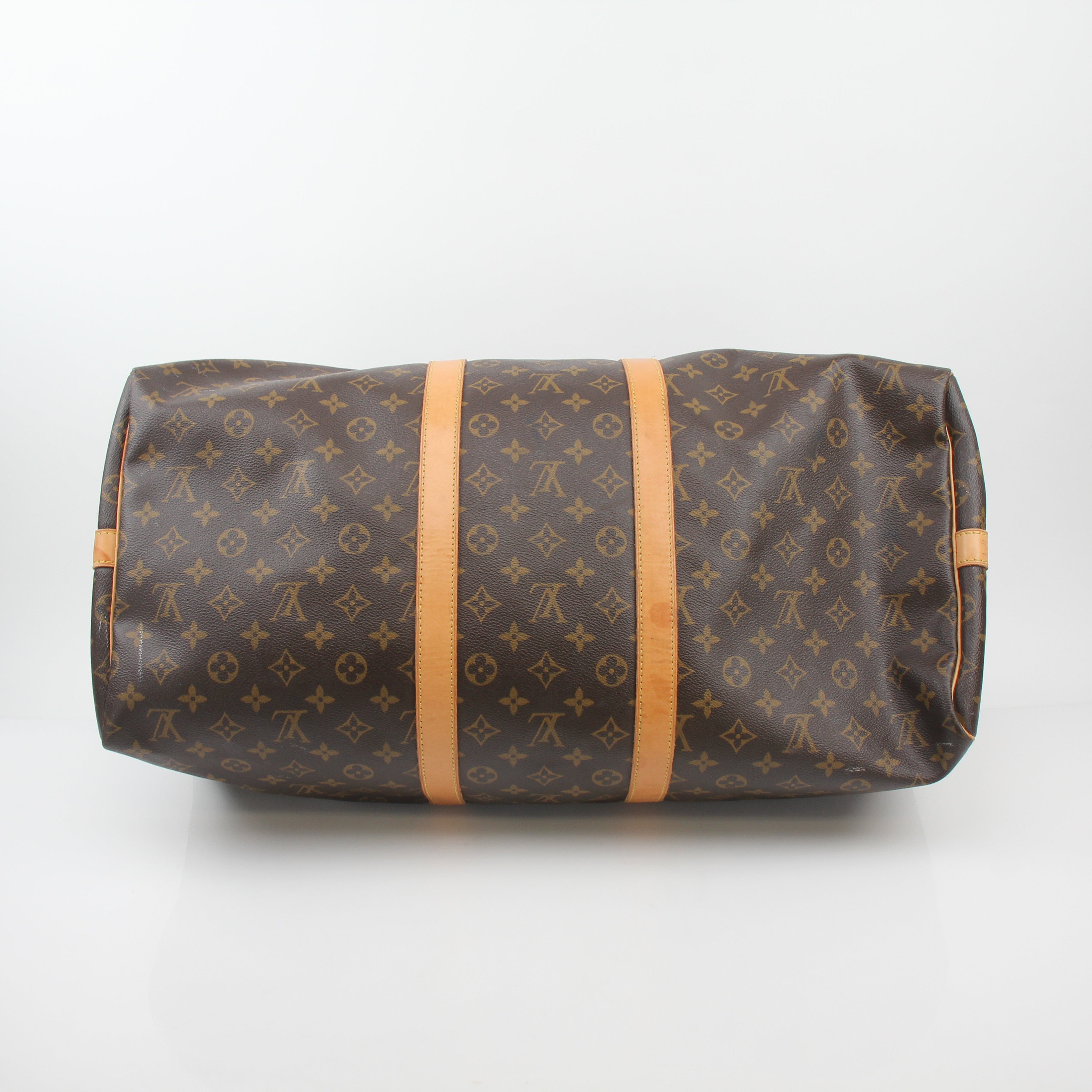 Louis Vuitton Monogram Keepall Bandoulière 55 duffel bag with leather trim and gold-tone hardware, designed for travel and style.