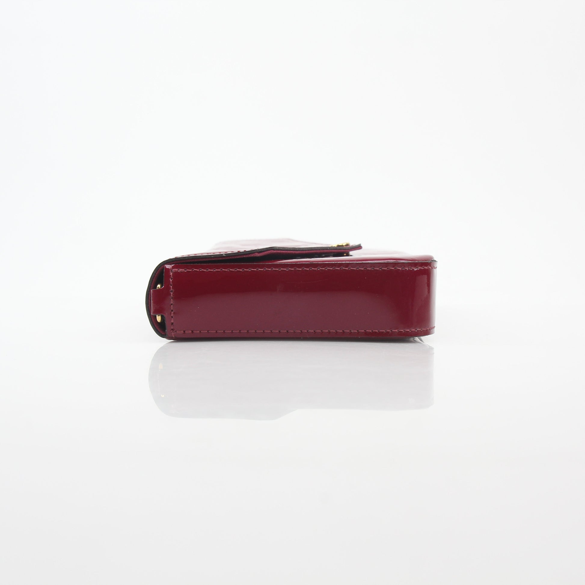 Red Louis Vuitton Monogram Vernis Félicie handbag with gold hardware, featuring the signature pattern and sleek design.