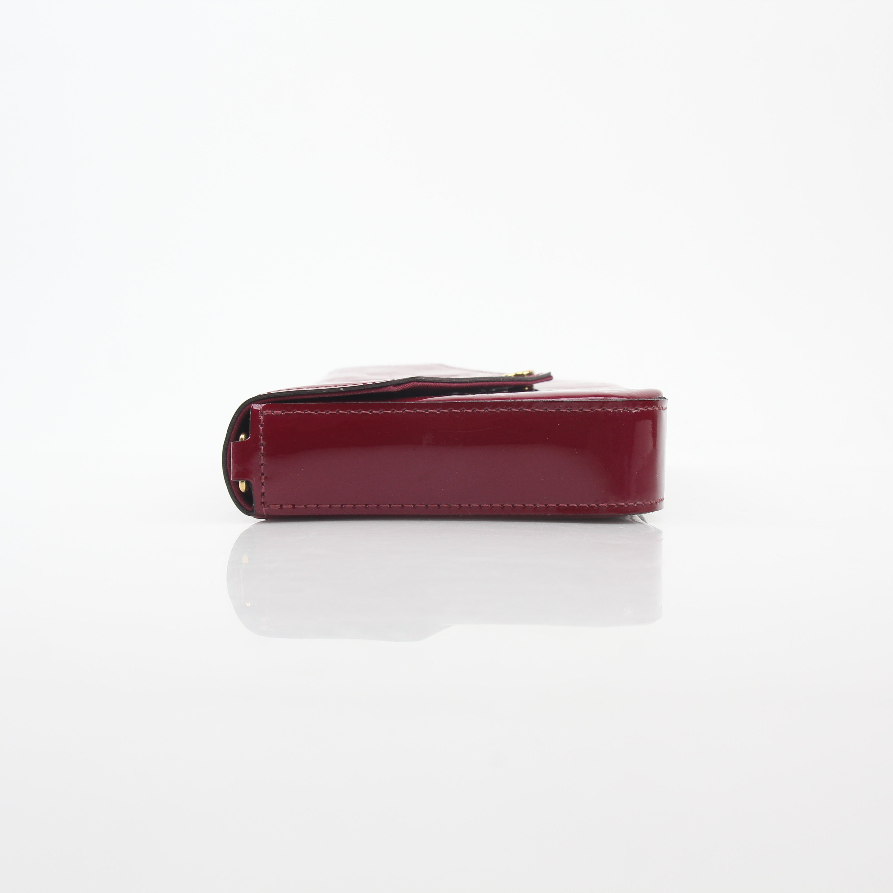 Red Louis Vuitton Monogram Vernis Félicie handbag with gold hardware, featuring the signature pattern and sleek design.