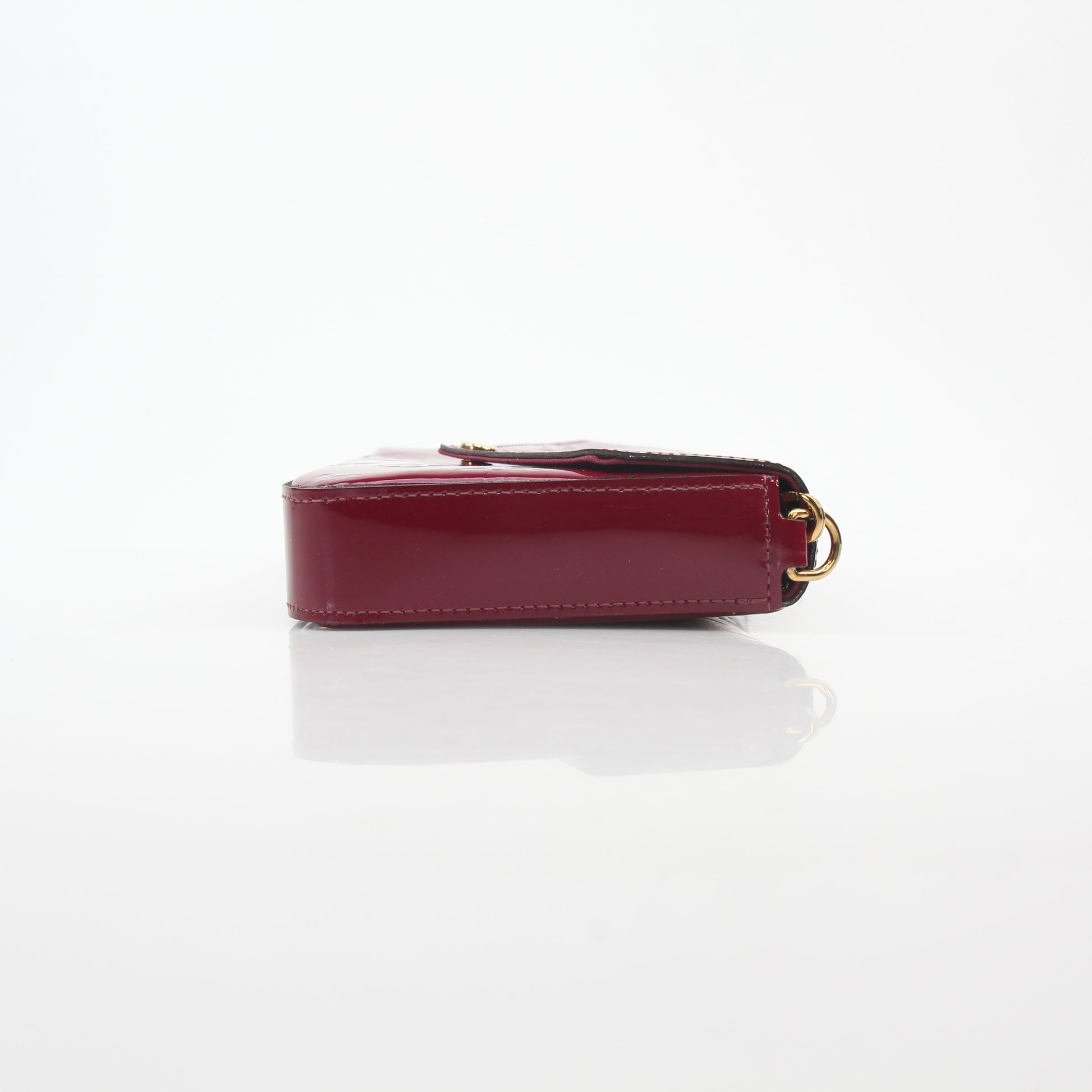 Red Louis Vuitton Monogram Vernis Pochette Félicie handbag with gold hardware, featuring a glossy finish and compact design.