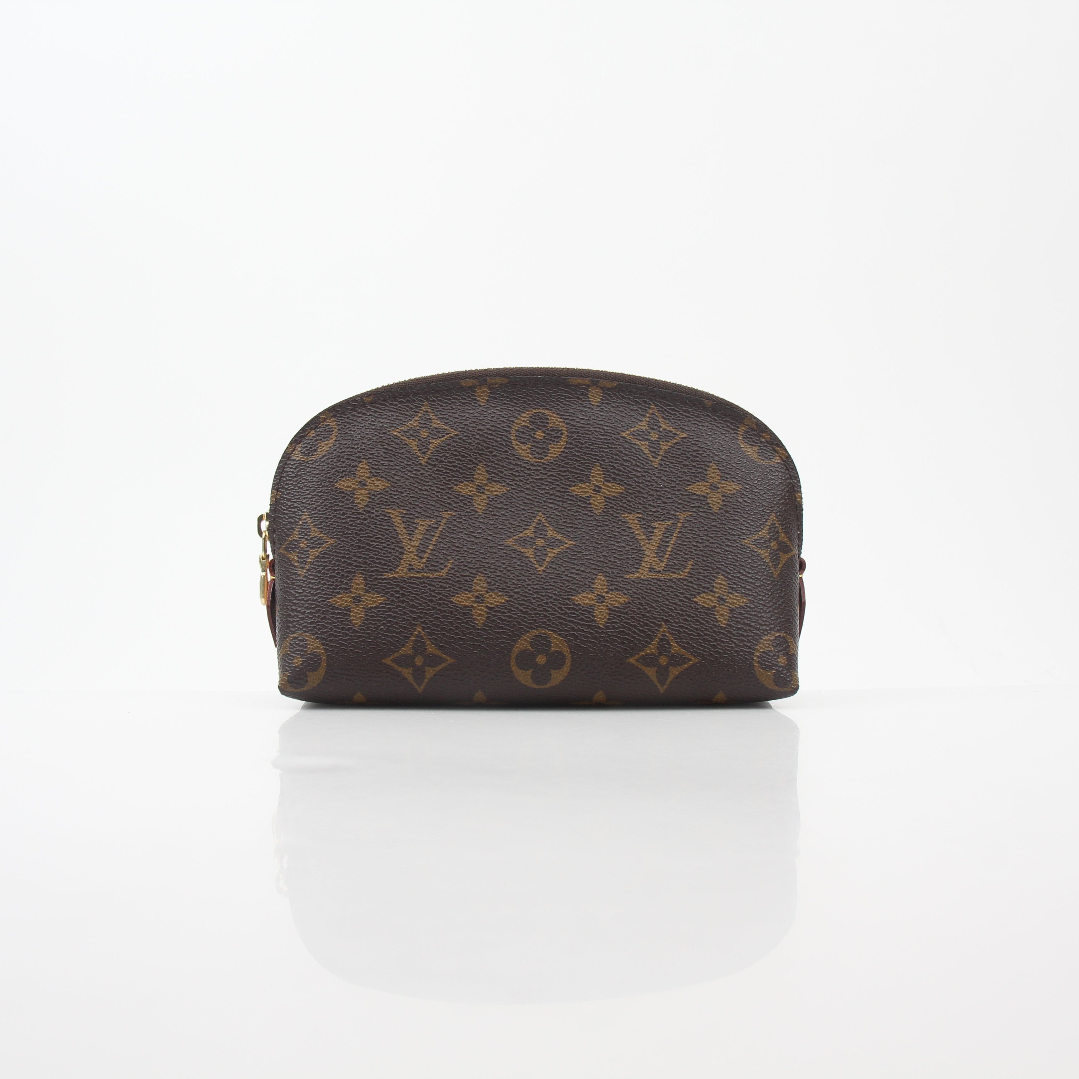 Louis Vuitton Monogram Cosmetic Pouch vanity case with gold accents and zipped closure, featuring iconic LV monogram pattern.
