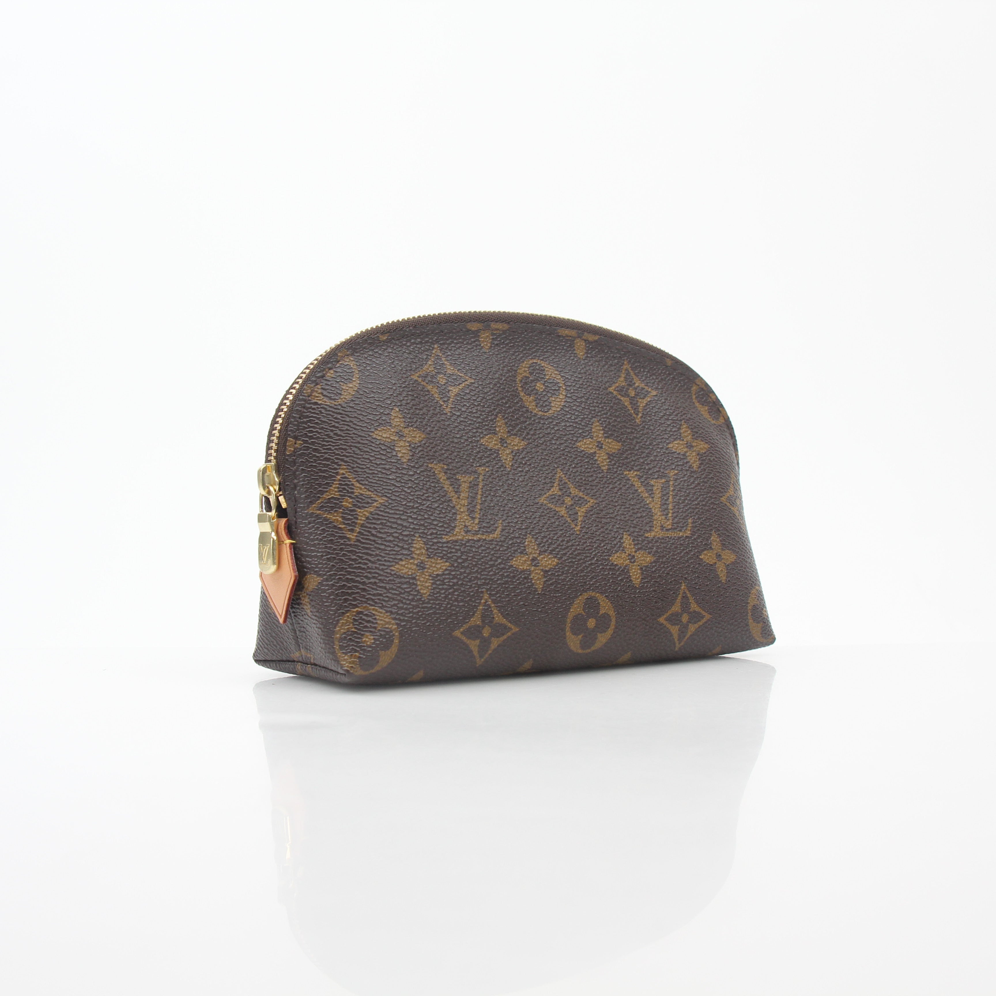 Louis Vuitton Monogram cosmetic pouch vanity case with gold accents, featuring the signature monogram pattern and zipper closure.