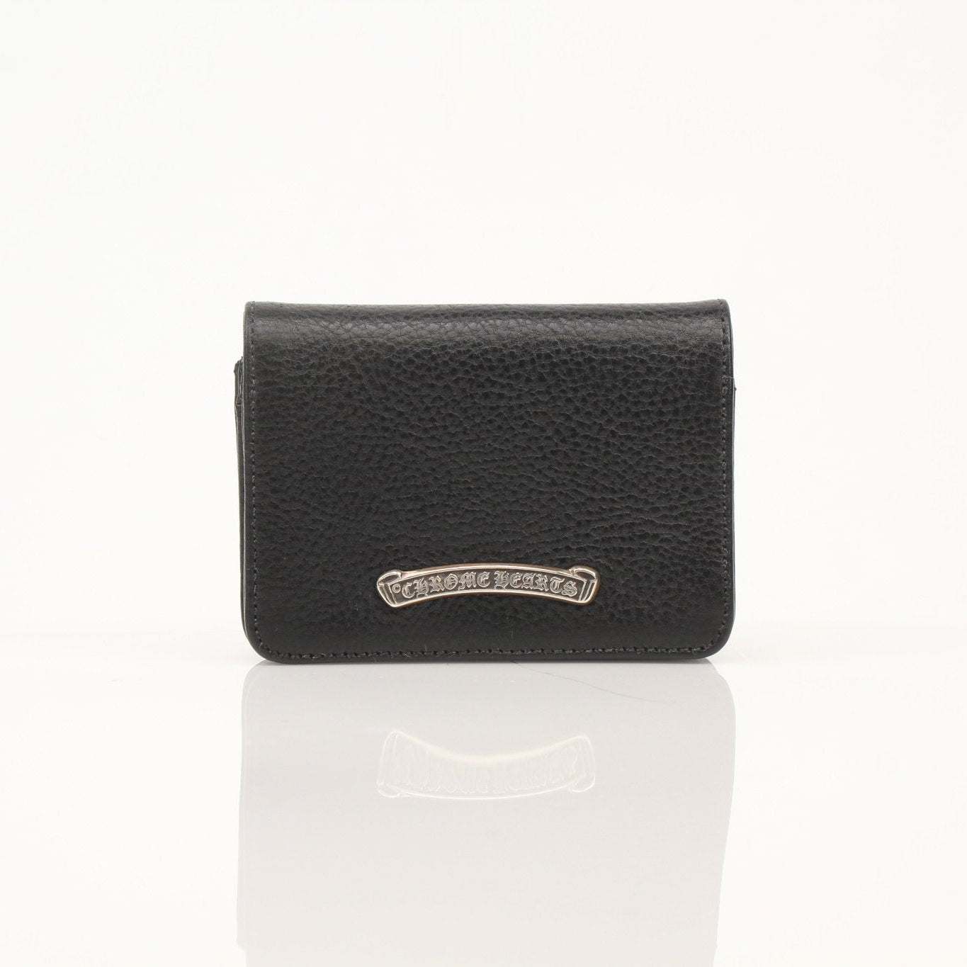 Chrome Hearts card wallet with chrome finish, compact design, and logo details visible in the image.