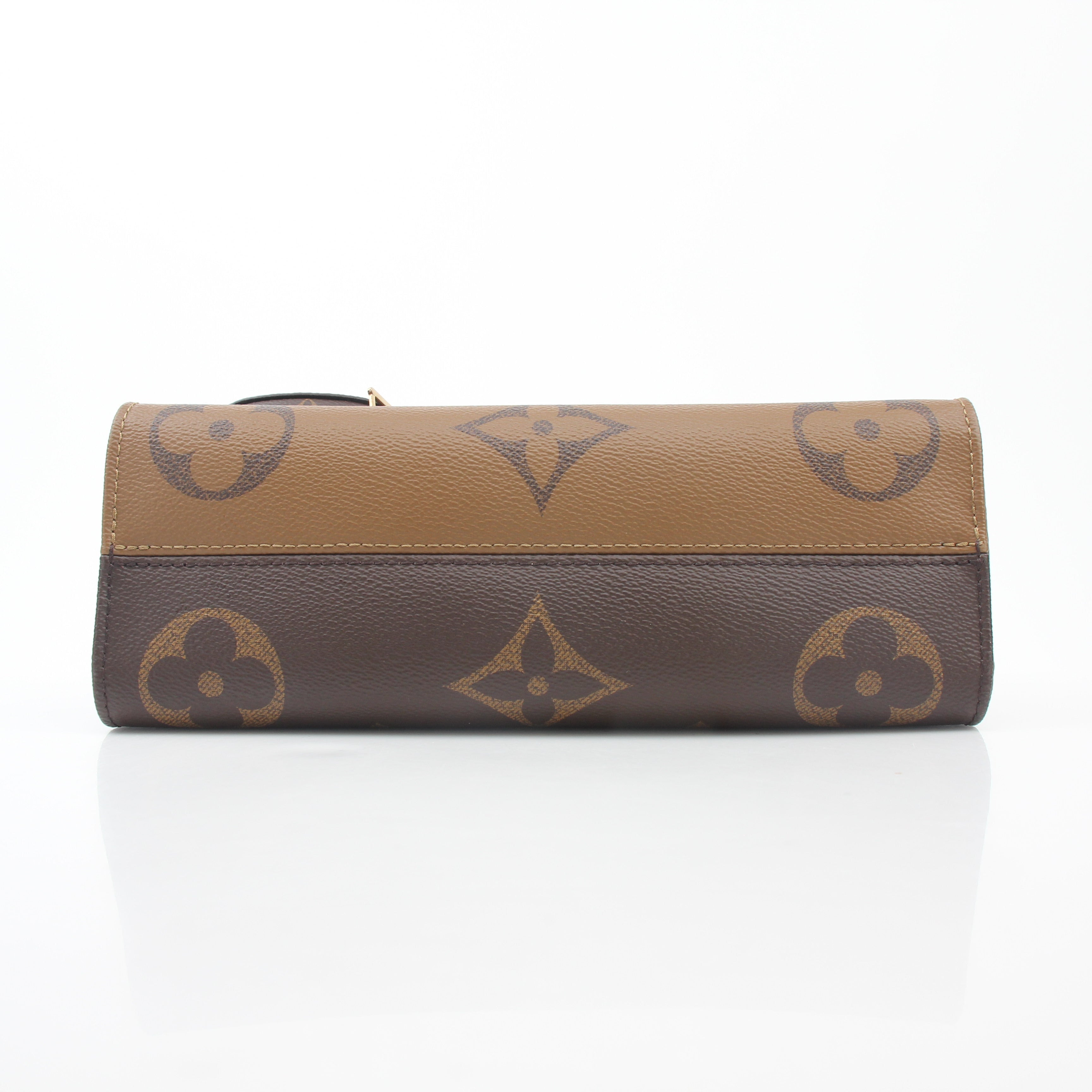 Louis Vuitton Brown Monogram OnTheGo East West handbag with gold accents, featuring dual top handles and a spacious interior.