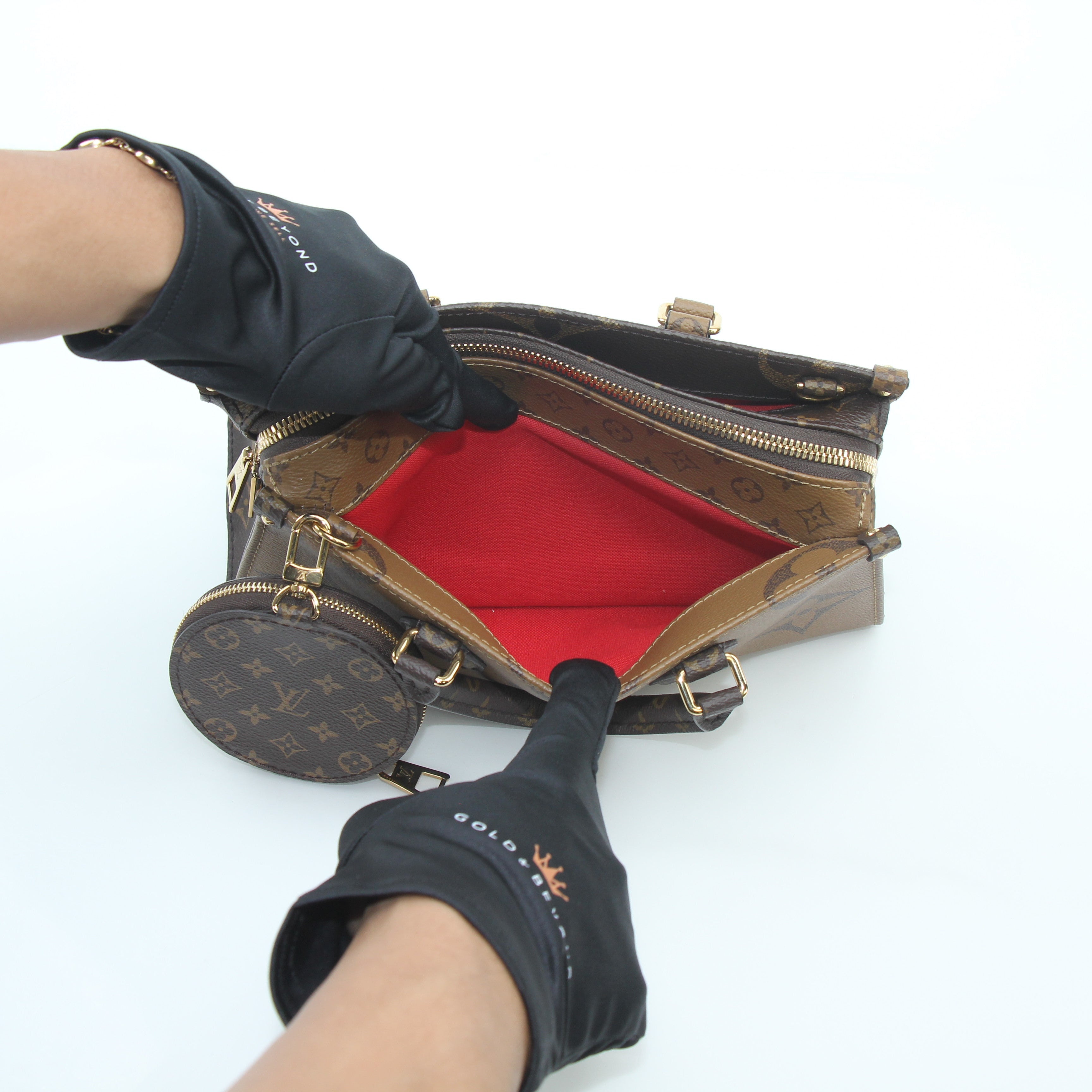 Louis Vuitton brown Monogram OnTheGo East West handbag with gold hardware, featuring the signature LV monogram pattern and structured design.