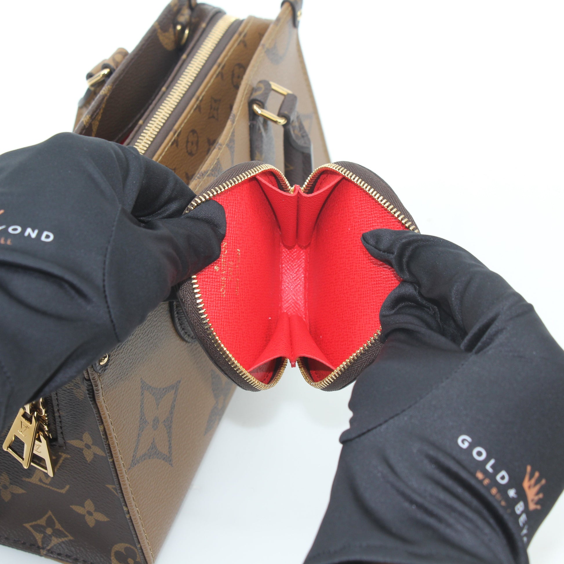 Louis Vuitton brown Monogram OnTheGo East West handbag with gold hardware, showing the stylish monogram pattern and leather accents.