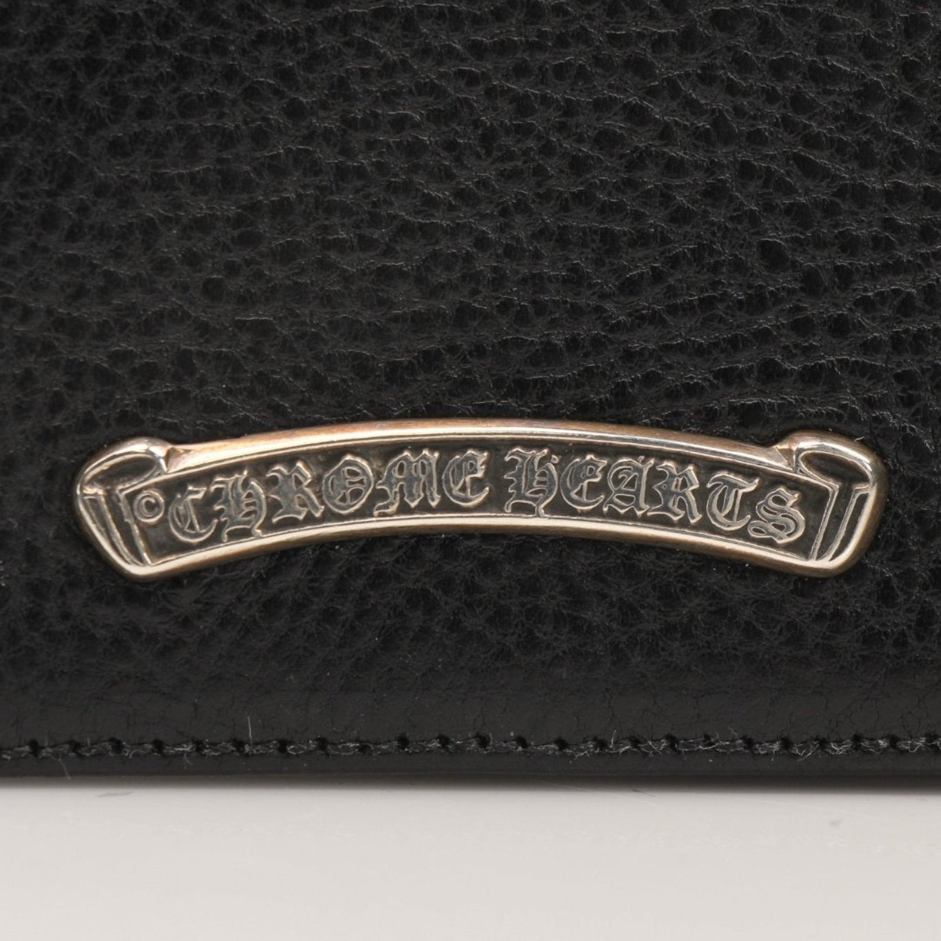Chrome Hearts leather card wallet with silver hardware and embossed logo, compact and stylish for everyday use.