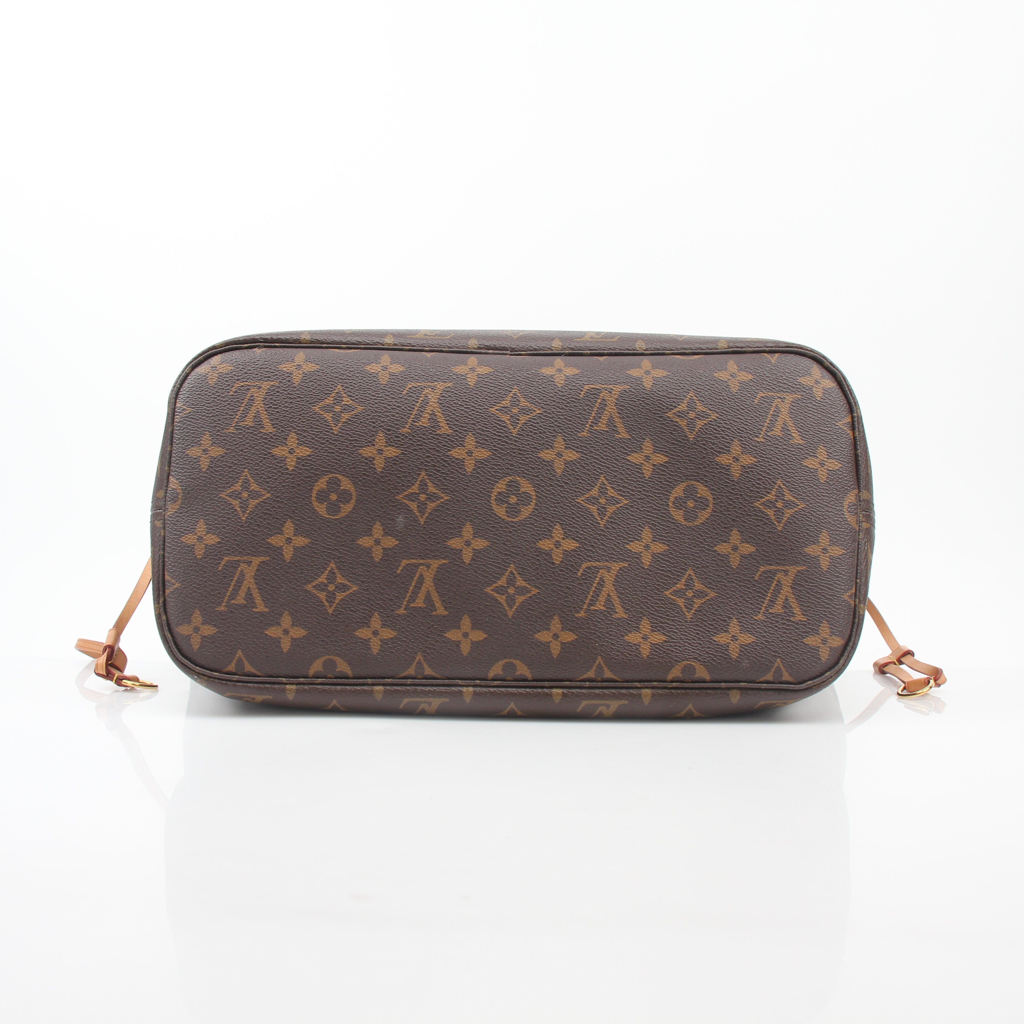 Louis Vuitton Monogram Neverfull MM tote bag with leather handles and spacious interior, displayed on a neutral background.
