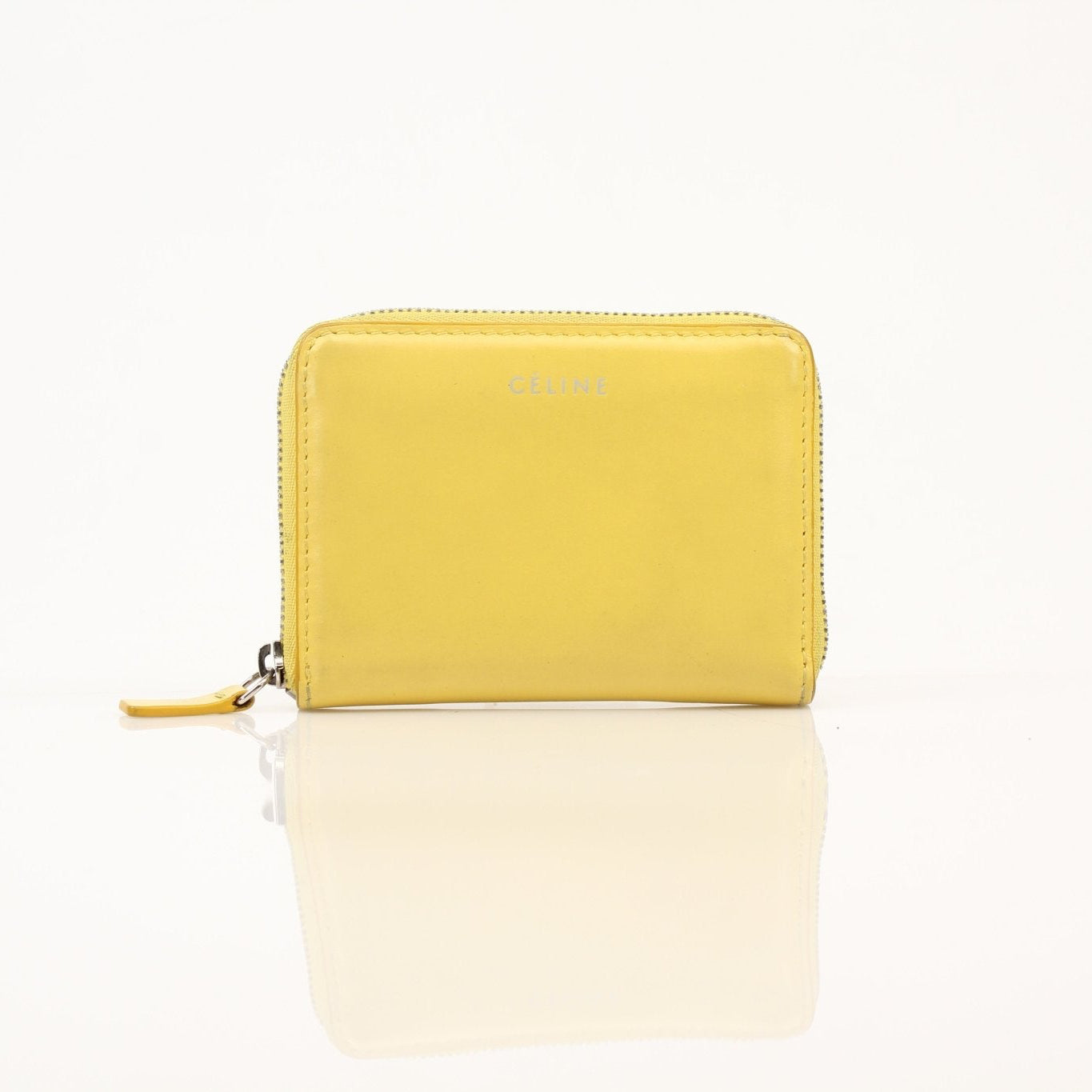 Gold & Beyond Celine Compact Zipped Wallet with leather exterior and zip closure lying open showing interior compartments.