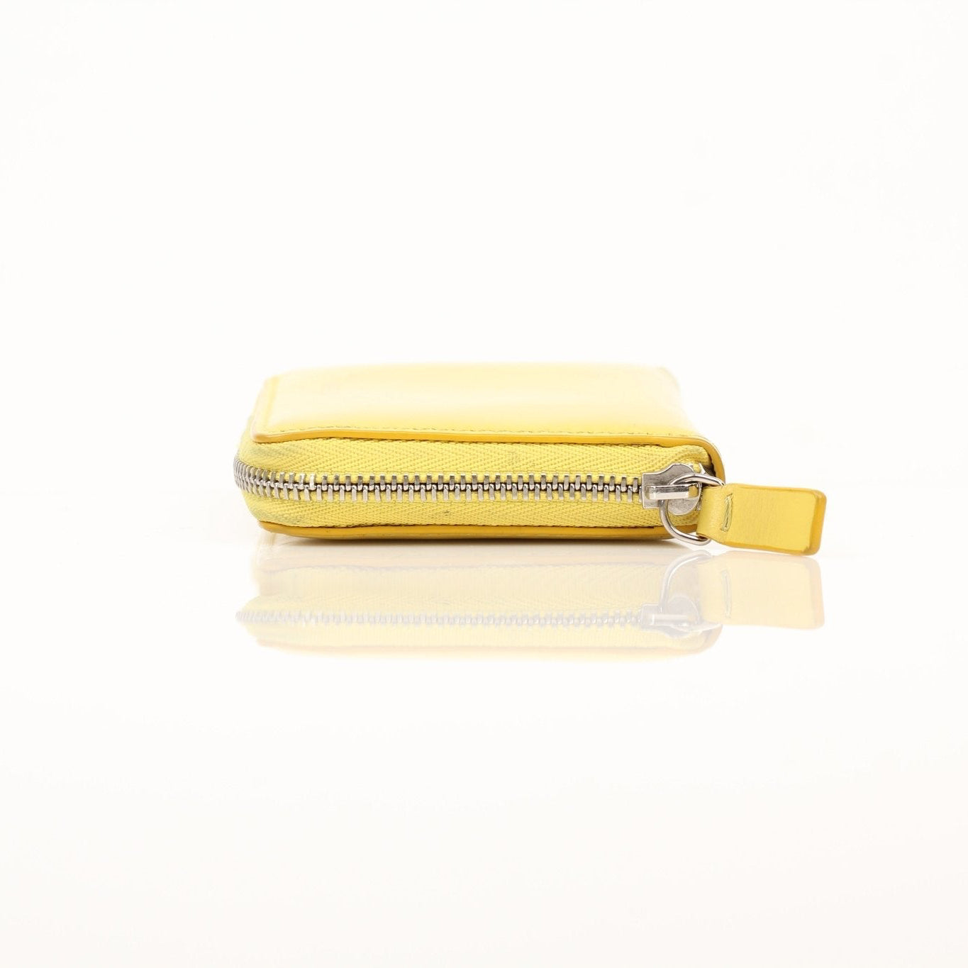 Gold & Beyond Celine Compact Zipped Wallet showing the black leather exterior with gold zipper and compact design.