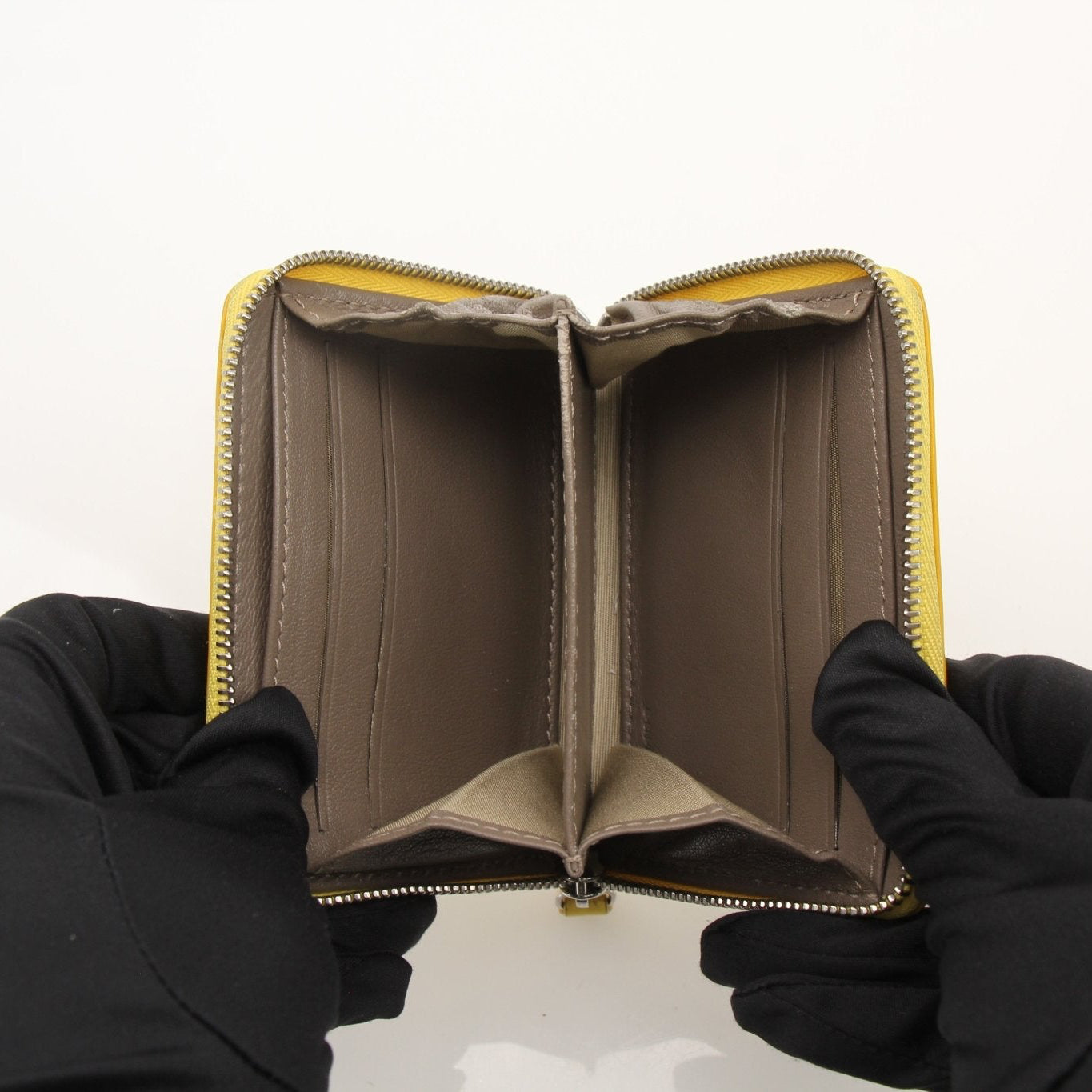 Gold & Beyond Celine compact zipped wallet with gold-tone zipper and leather exterior, showcasing a sleek, stylish design.
