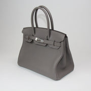 Hermès Birkin 30 handbag in luxurious leather with gold hardware, featuring double handles and a spacious interior.