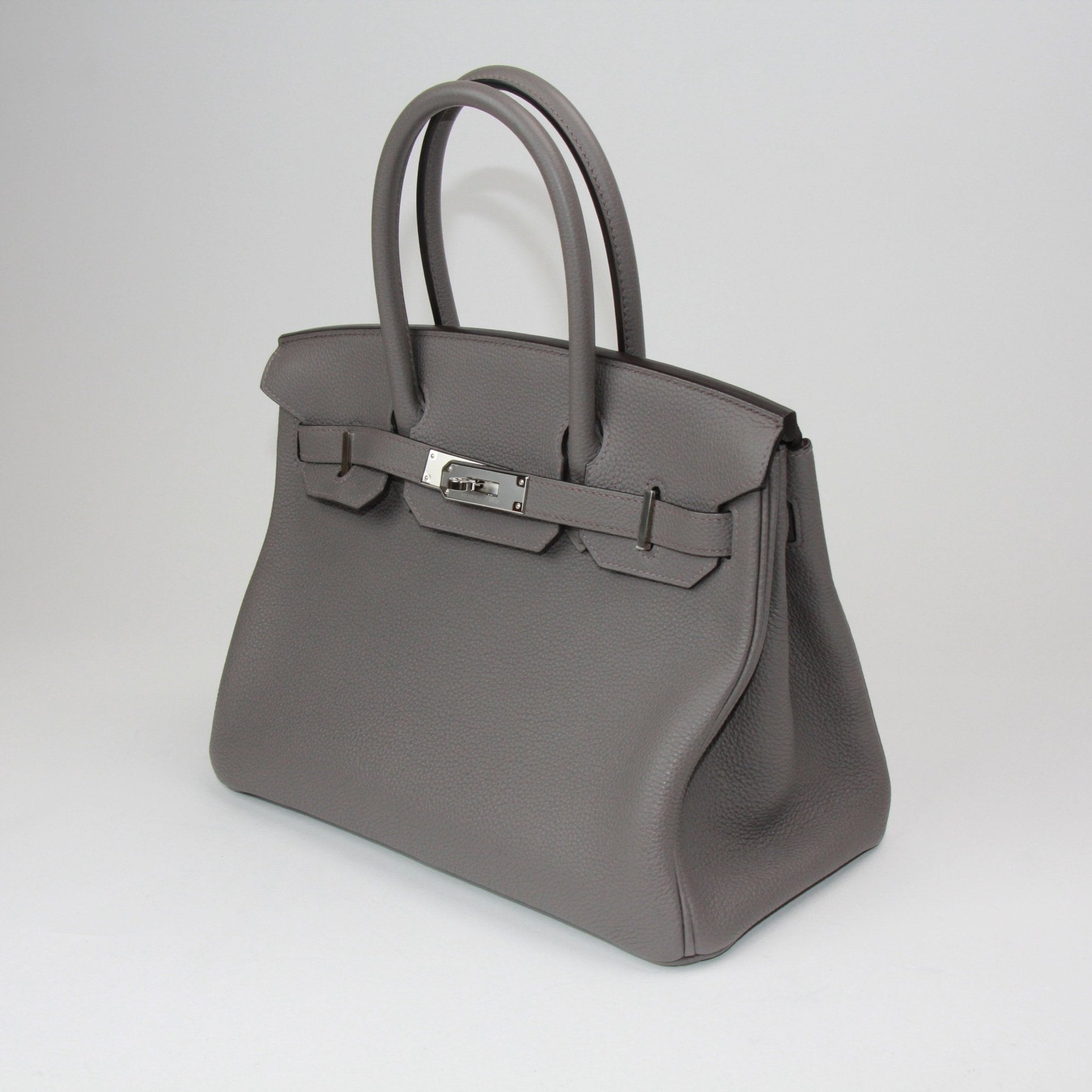 Hermès Birkin 30 handbag in luxurious leather with gold hardware, featuring double handles and a spacious interior.