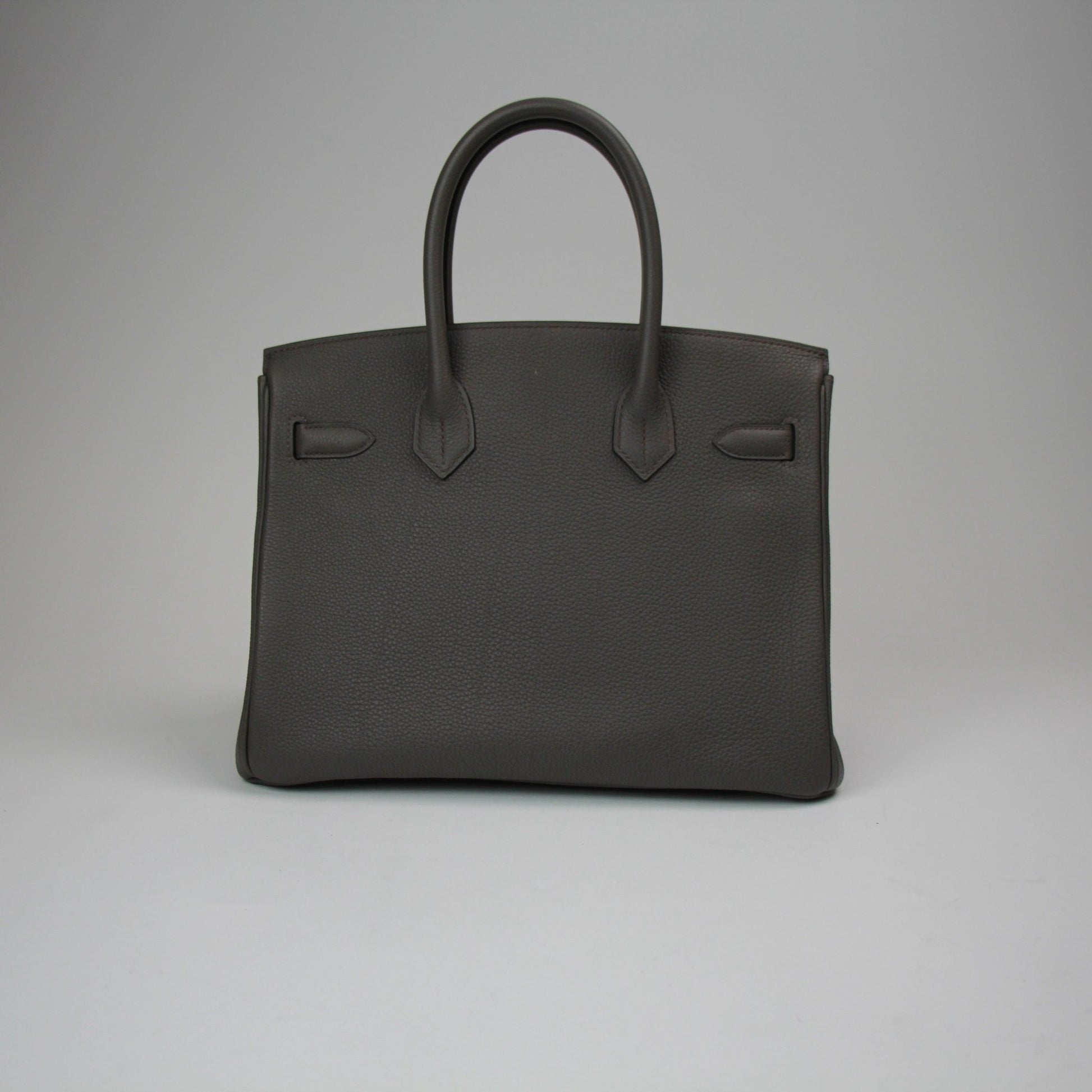 Hermès Birkin 30 handbag in luxurious leather with gold hardware, displayed on a neutral background.