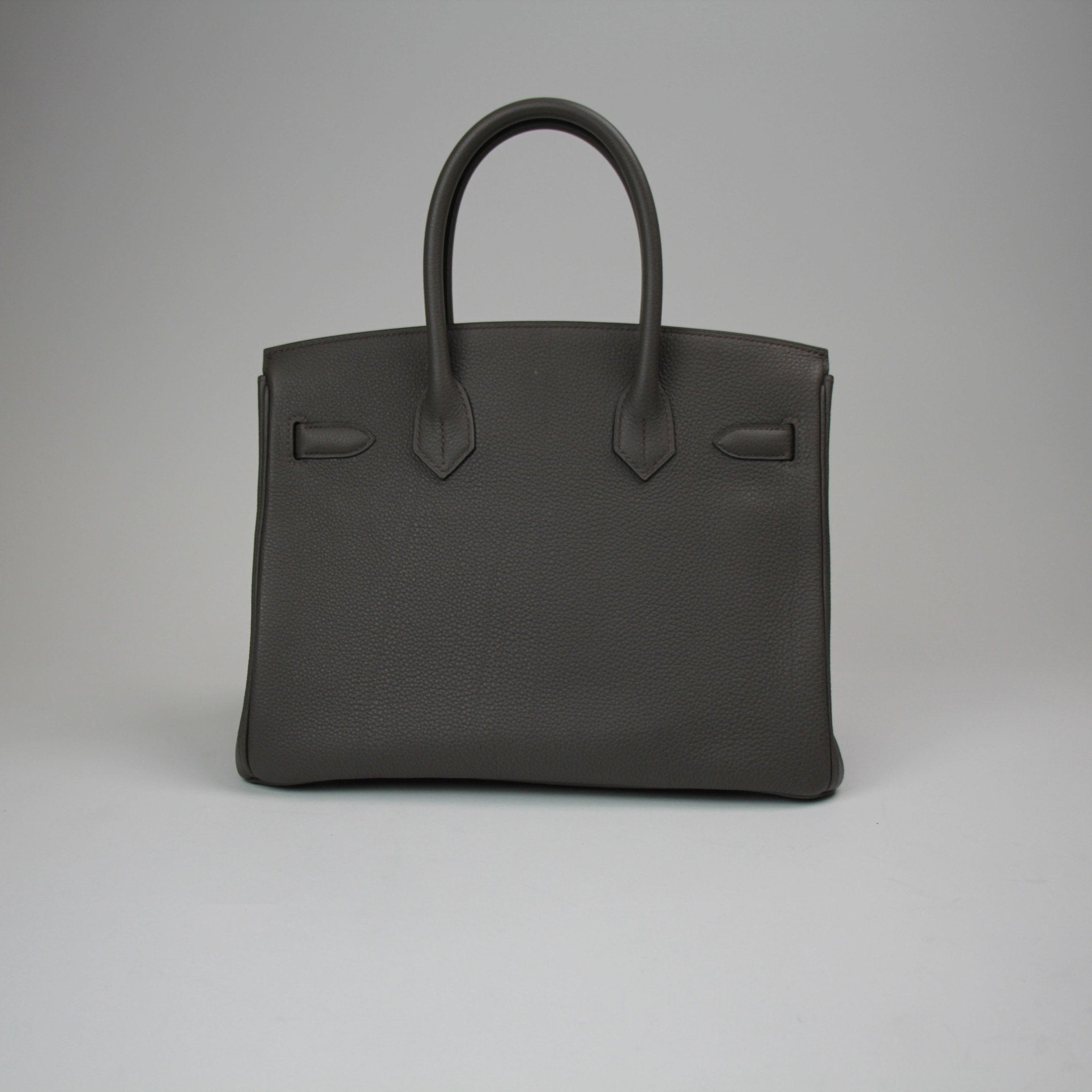 Hermès Birkin 30 handbag in luxurious leather with gold hardware, displayed on a neutral background.