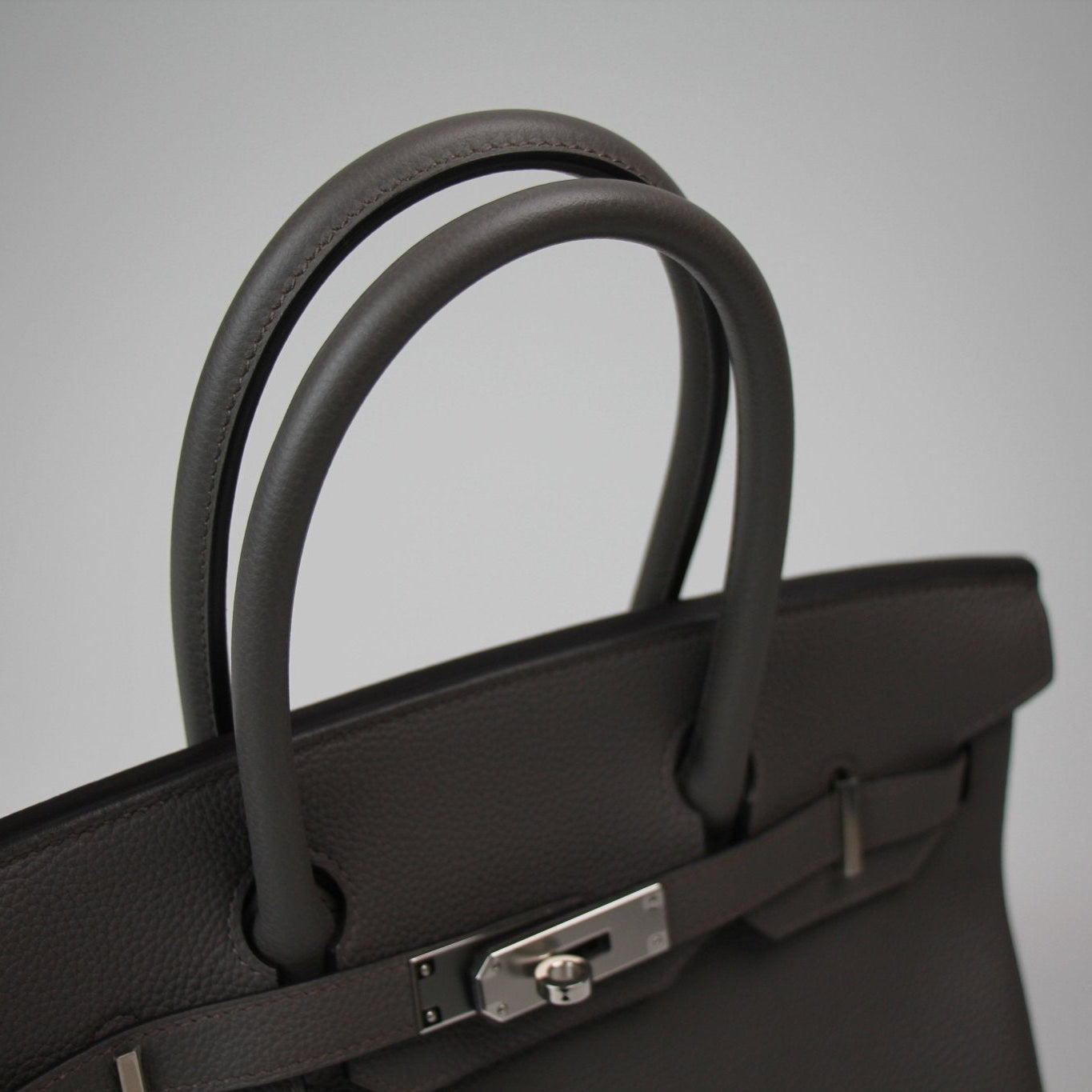 Hermès Birkin 30 handbag in tan leather with gold hardware, featuring double top handles and classic design.
