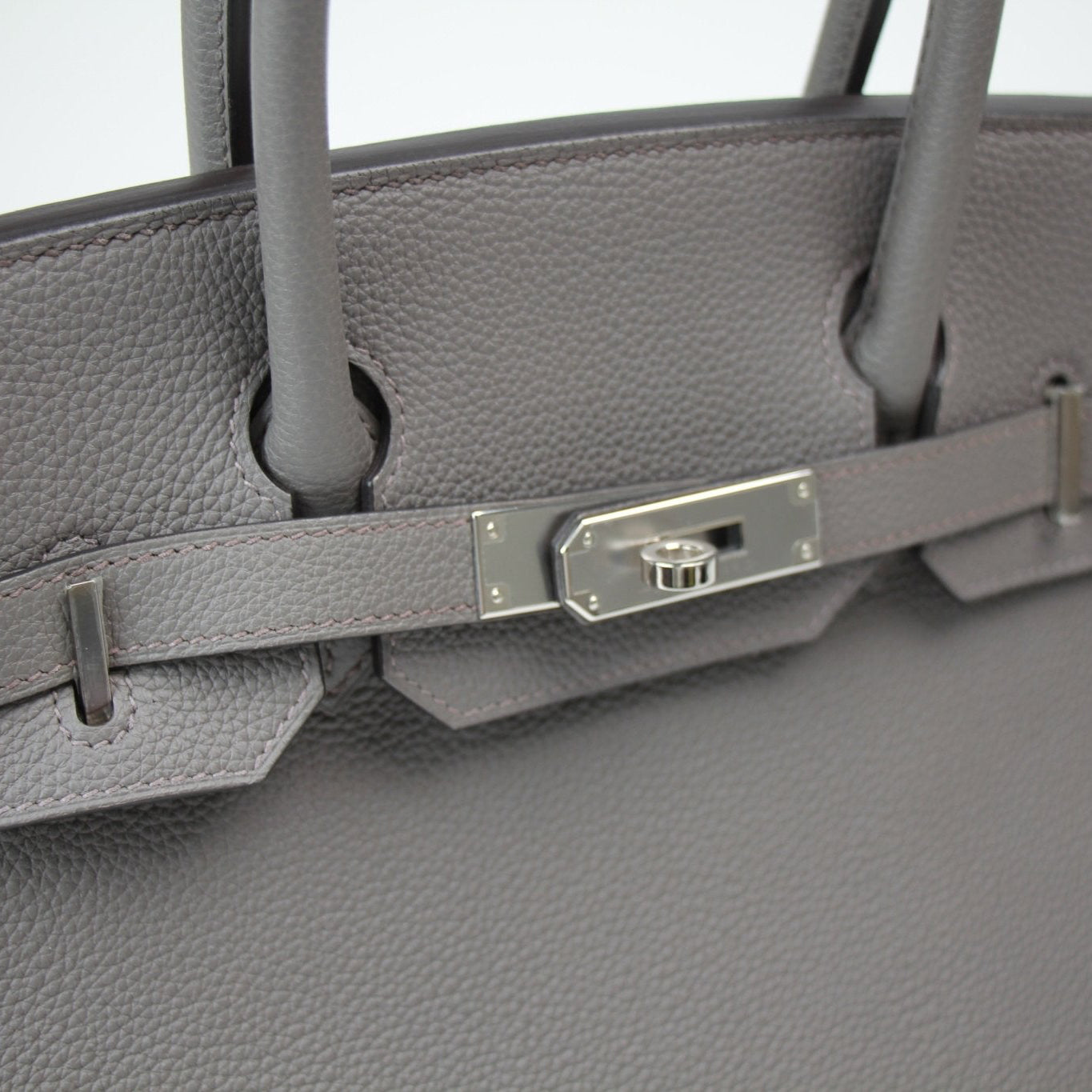 Hermès Birkin 30 handbag in gold leather with silver hardware, featuring double top handles and a spacious interior.
