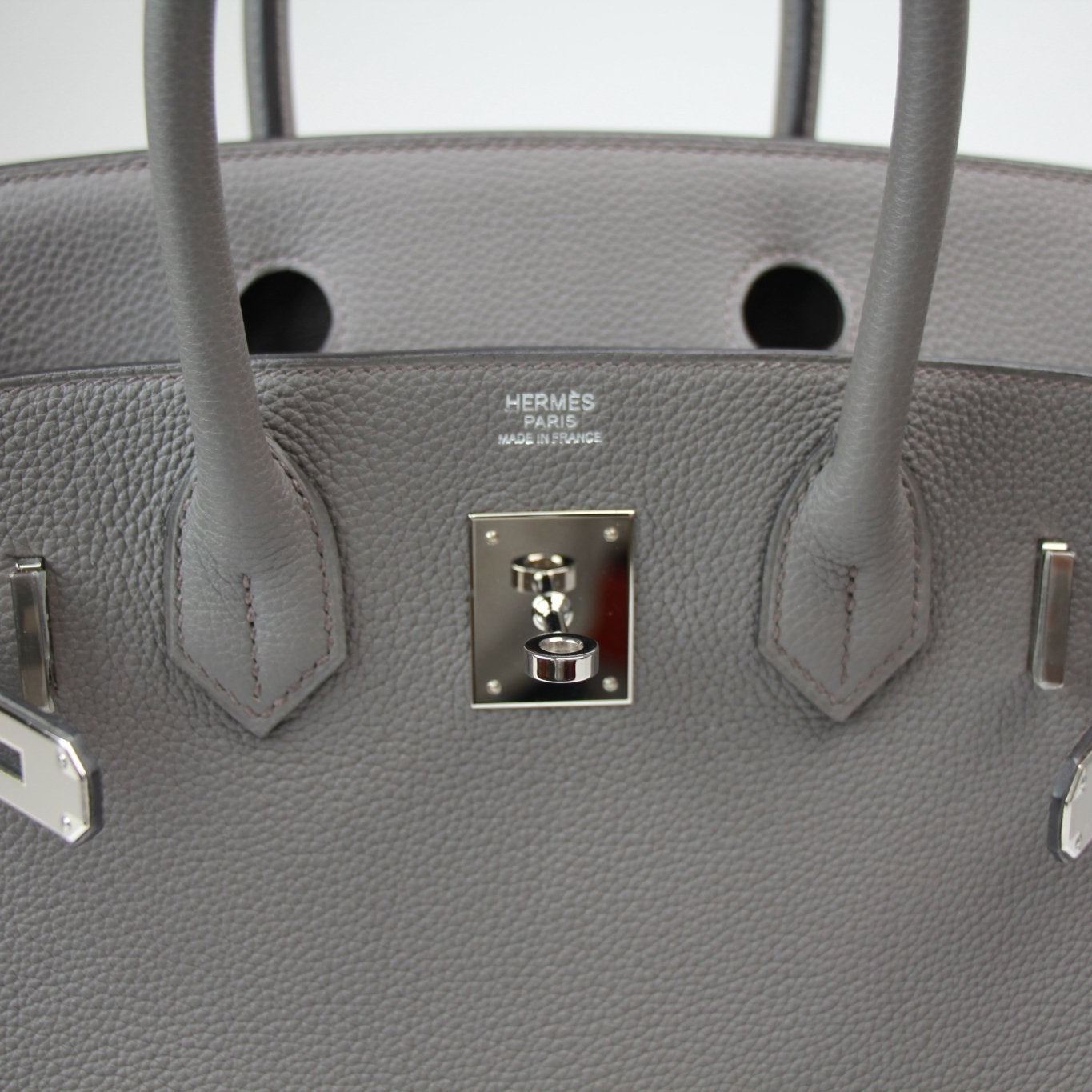 Hermès Birkin 30 handbag in luxurious leather with gold hardware, featuring top handles and classic design.