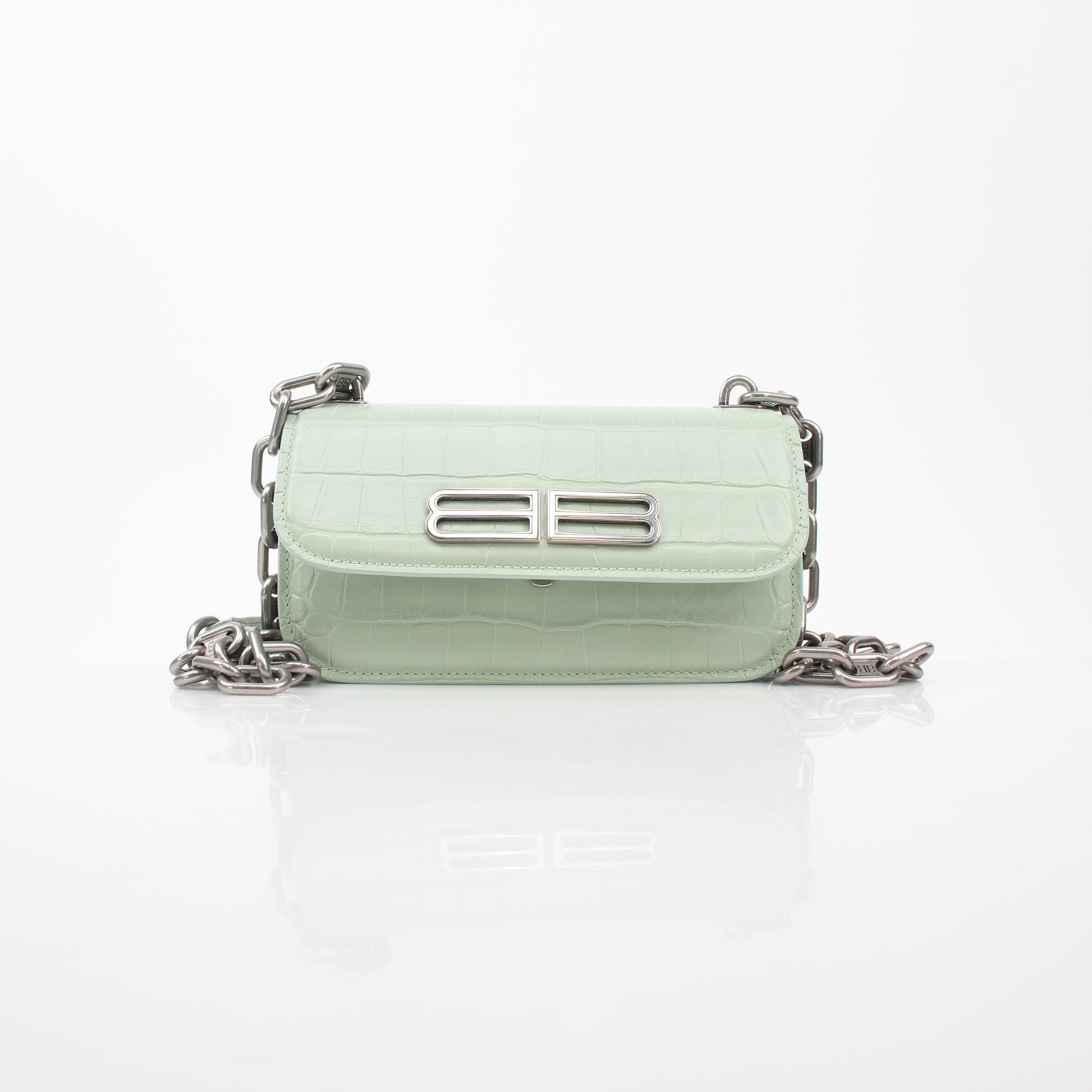 Light green Balenciaga Gossip XS chain handbag with gold hardware and textured leather, featuring a compact, stylish design.