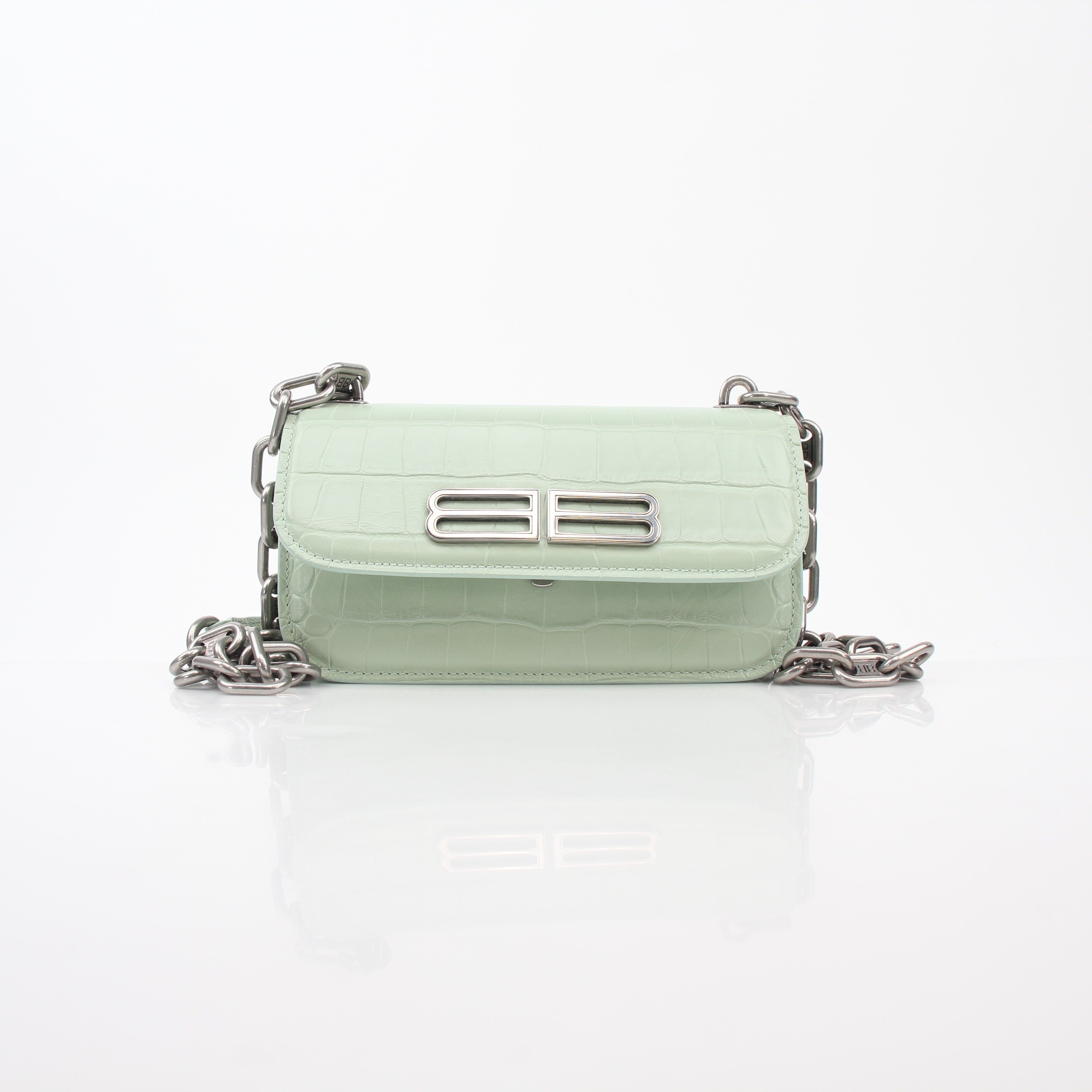Light green Balenciaga Gossip XS chain handbag with gold hardware and textured leather, featuring a compact, stylish design.